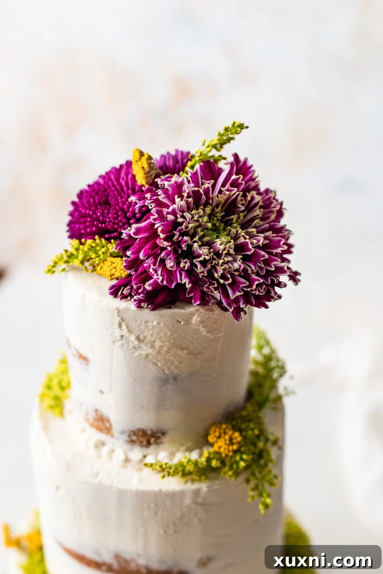 Close-up of a beautiful vegan wedding cake with fresh floral decorations