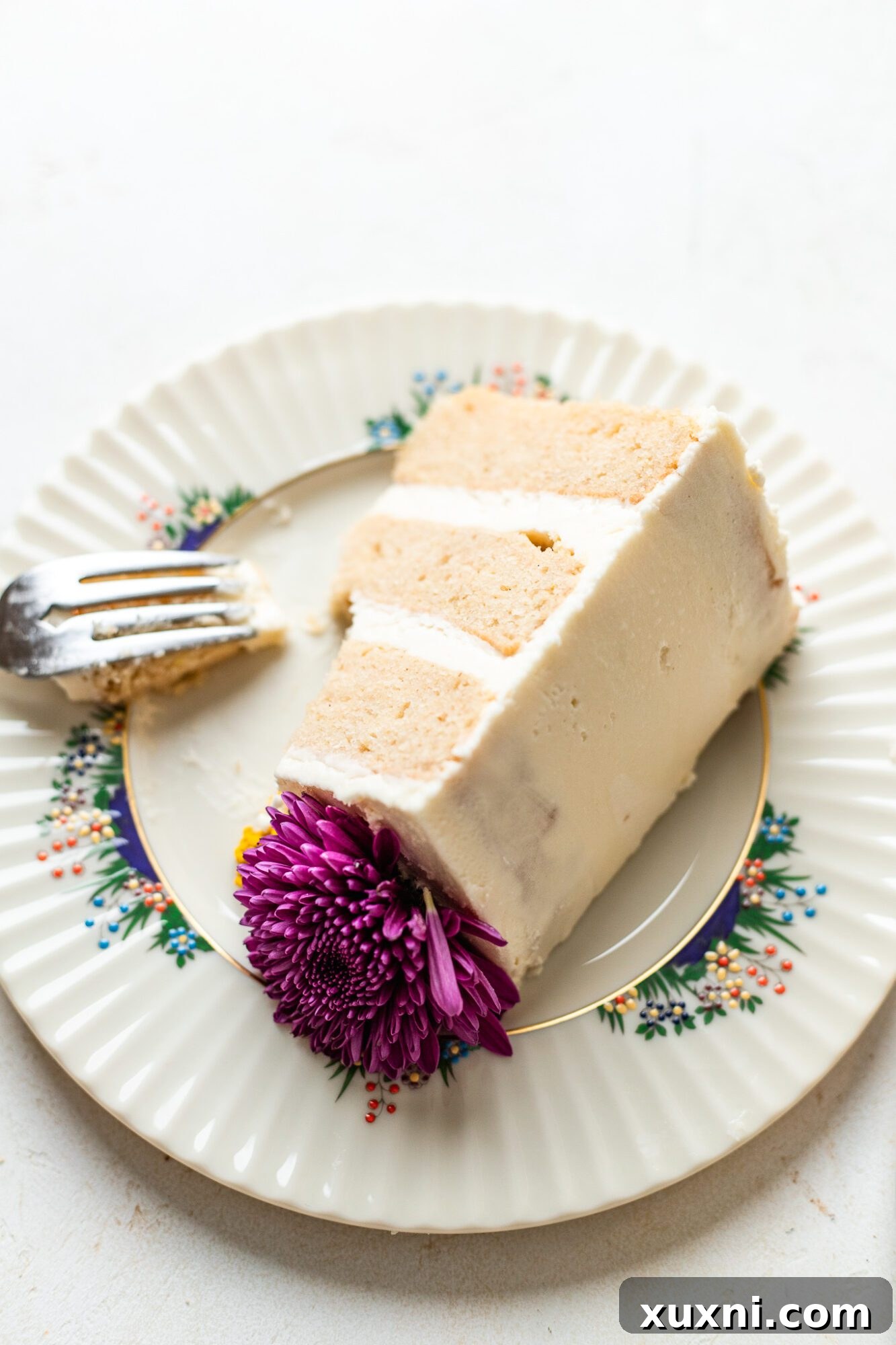 A beautiful slice of vegan wedding cake, showcasing its moist texture and rich frosting