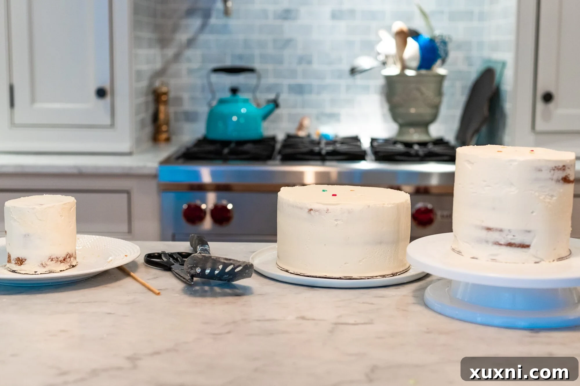 Hands carefully gathering vegan cake tiers on cake boards, ready for stacking
