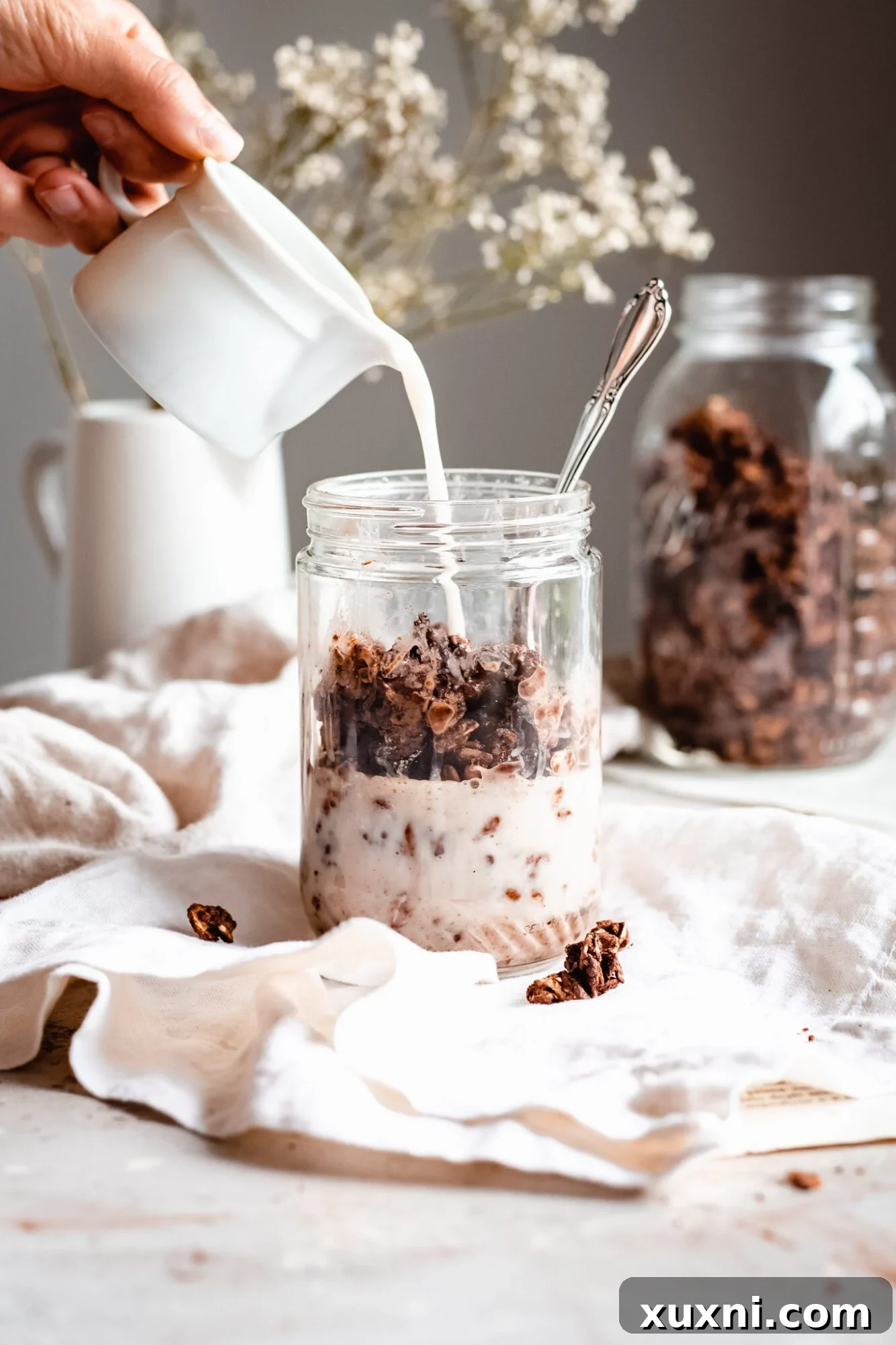 hand pouring oat milk into granola