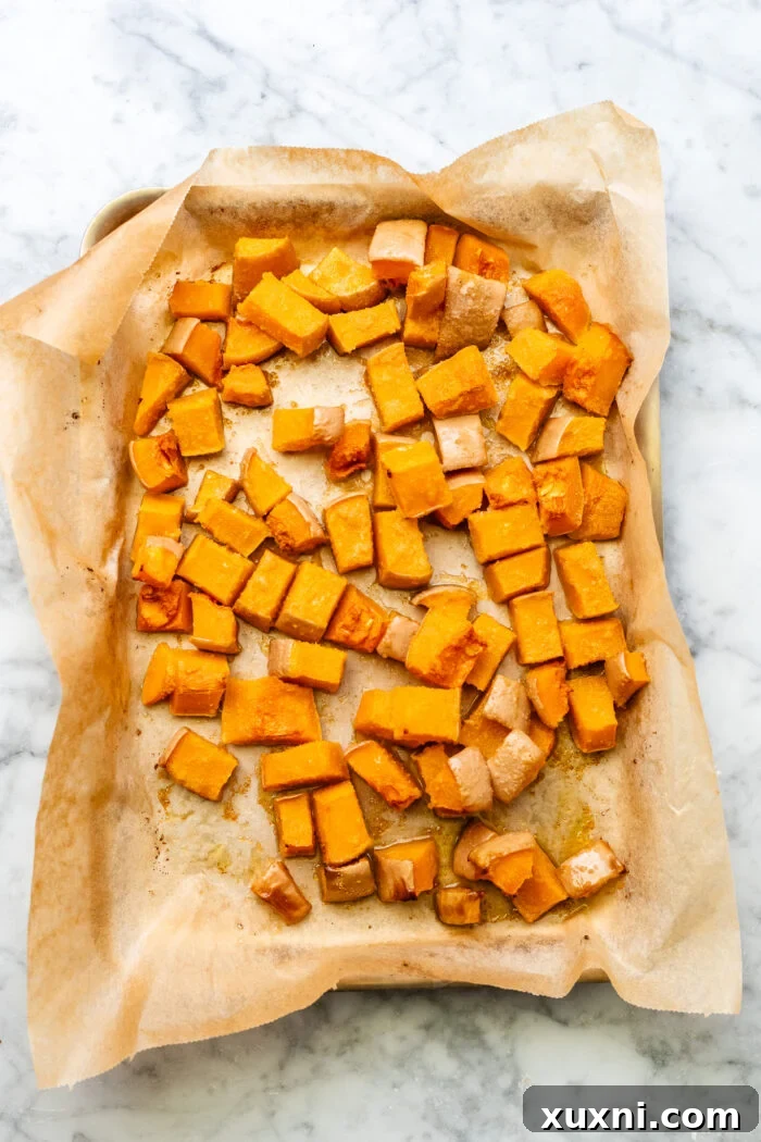 Roasted Butternut Squash Mac and Cheese Dairy Free Delight 5 roasted butternut squash cubes on a baking sheet