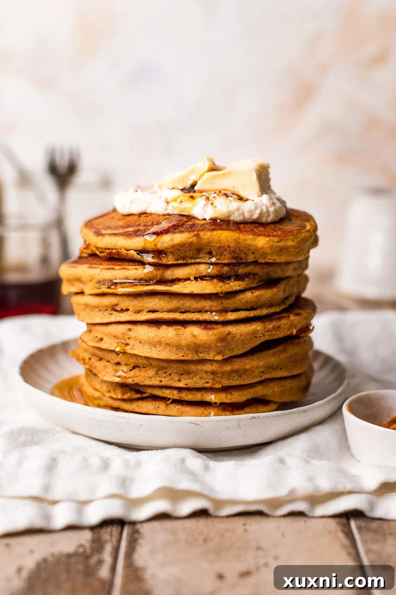 drizzle of maple syrup over pumpkin pancakes