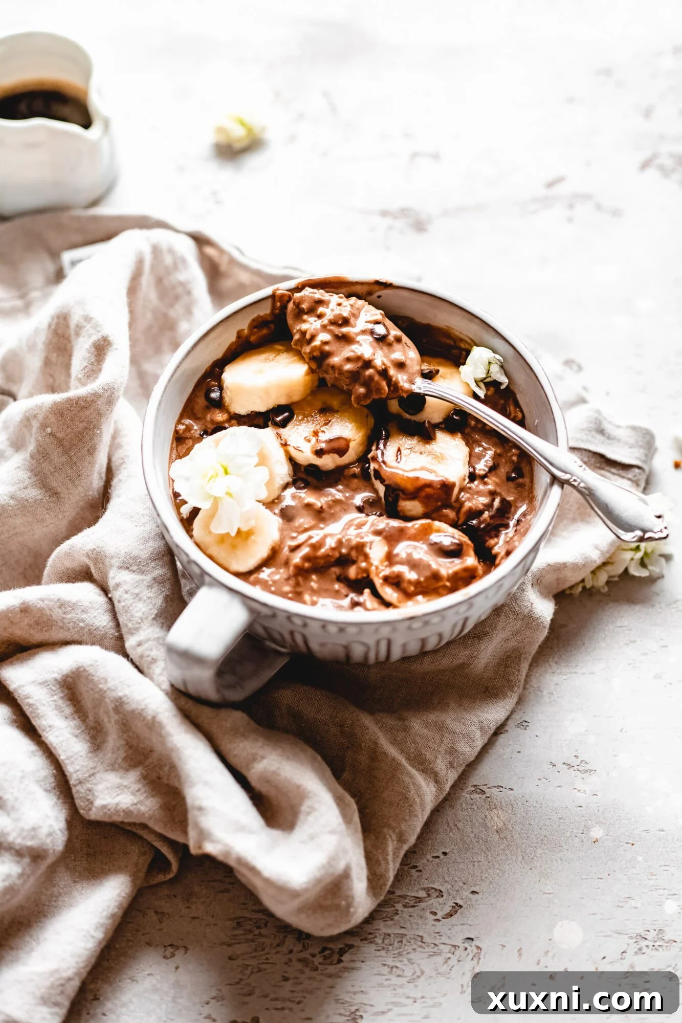 mug full of vegan overnight protein oats, ready to eat