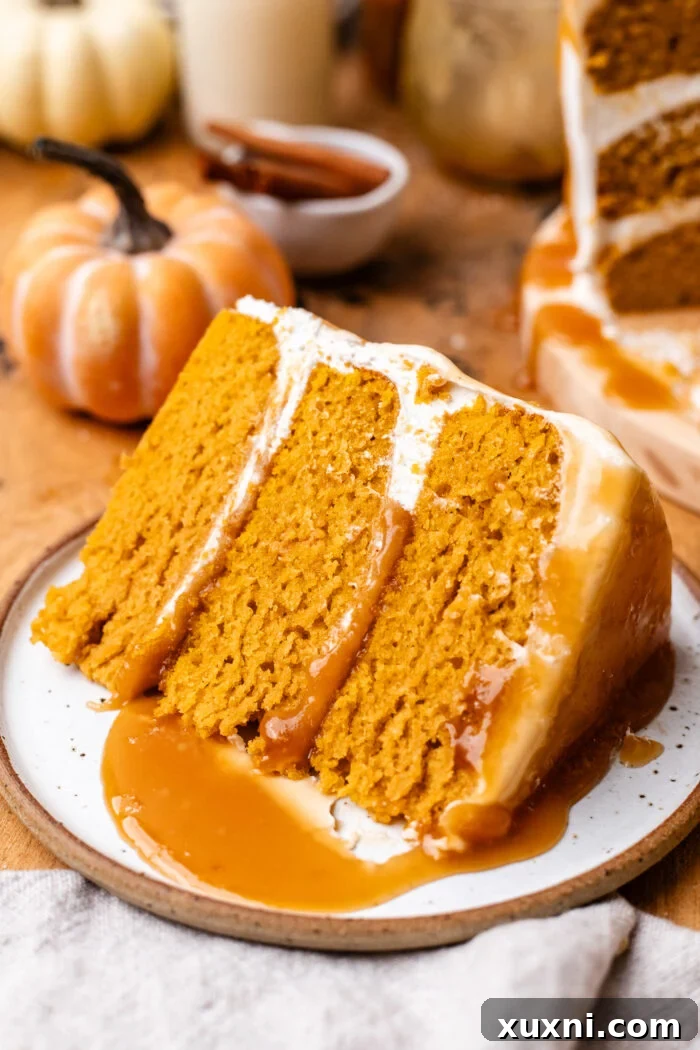 Close-up of a perfectly frosted slice of vegan pumpkin cake, highlighting its texture and creamy frosting.