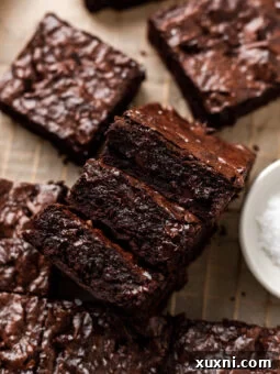 Sliced fudgy vegan brownies with shiny crinkle tops.