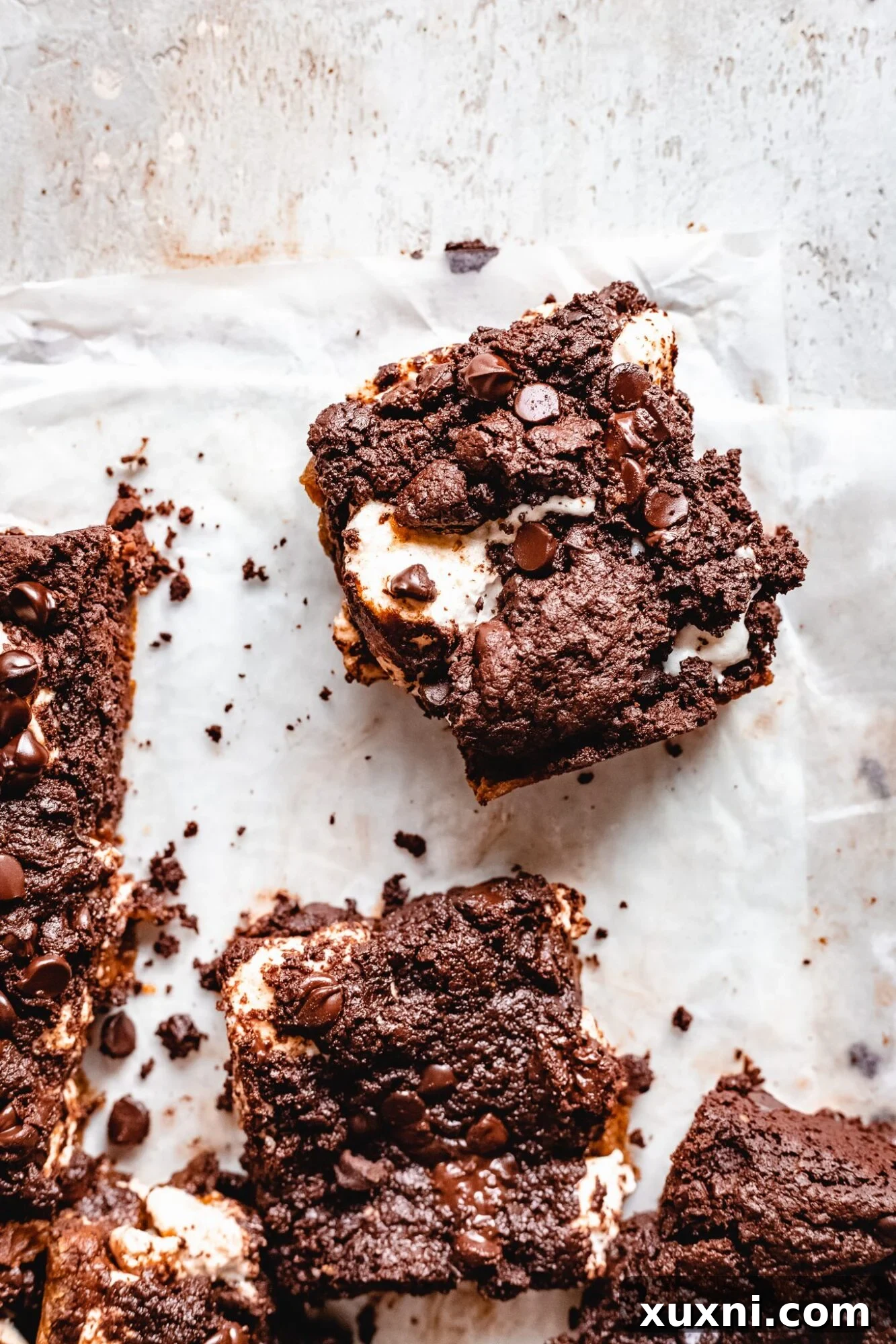 Vegan Smores Brownie Cookie Recipe 2 golden brown vegan s'mores brookie bars on parchment paper, fresh from the oven