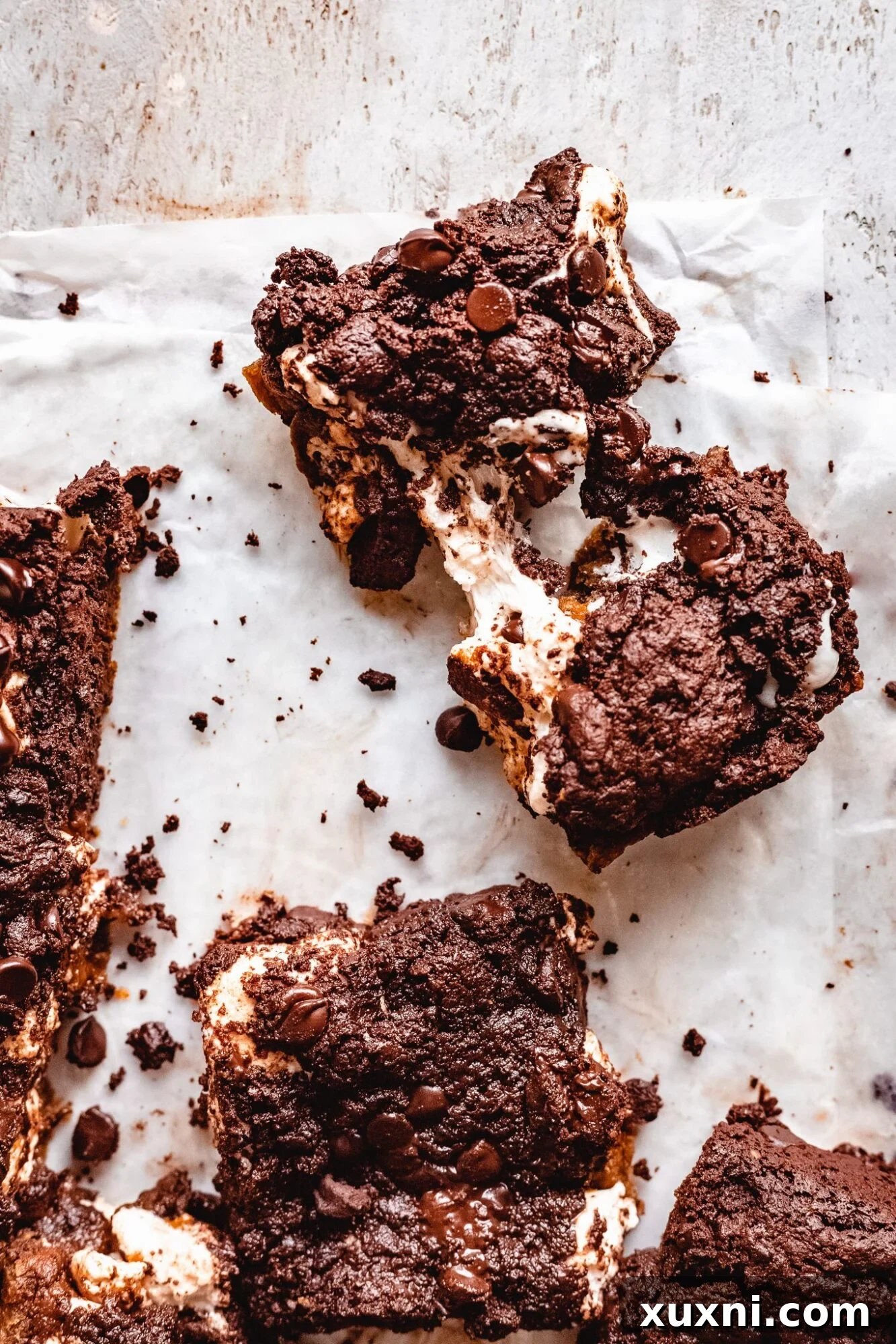 Vegan Smores Brownie Cookie Recipe 3 a freshly baked vegan s'mores brookie being pulled apart, revealing gooey marshmallow