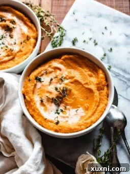 bowls of roasted sweet potato soup on marble