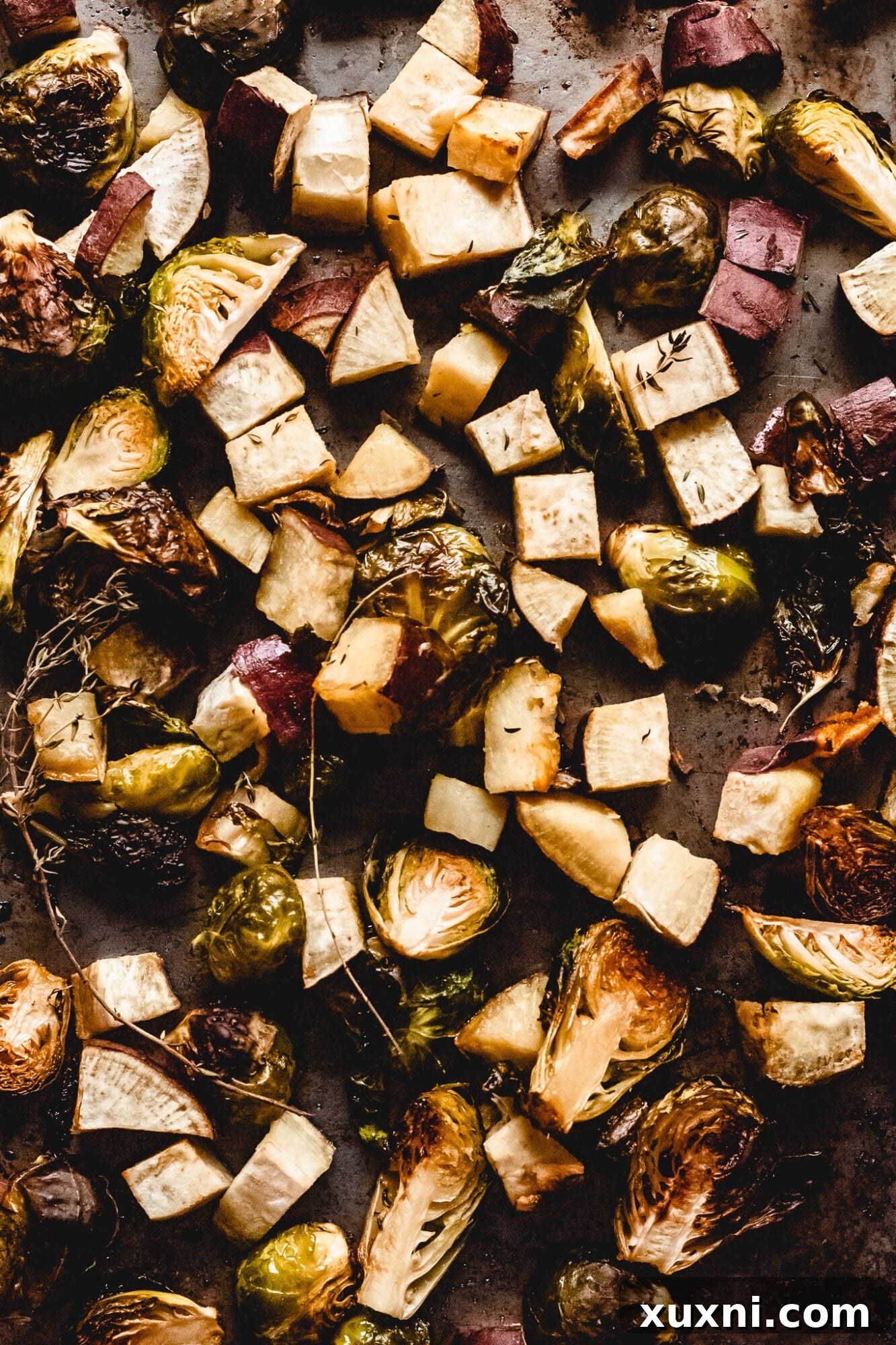 A close-up view of roasted Brussels sprouts on a sheet pan, perfectly charred and caramelized, ready for serving.