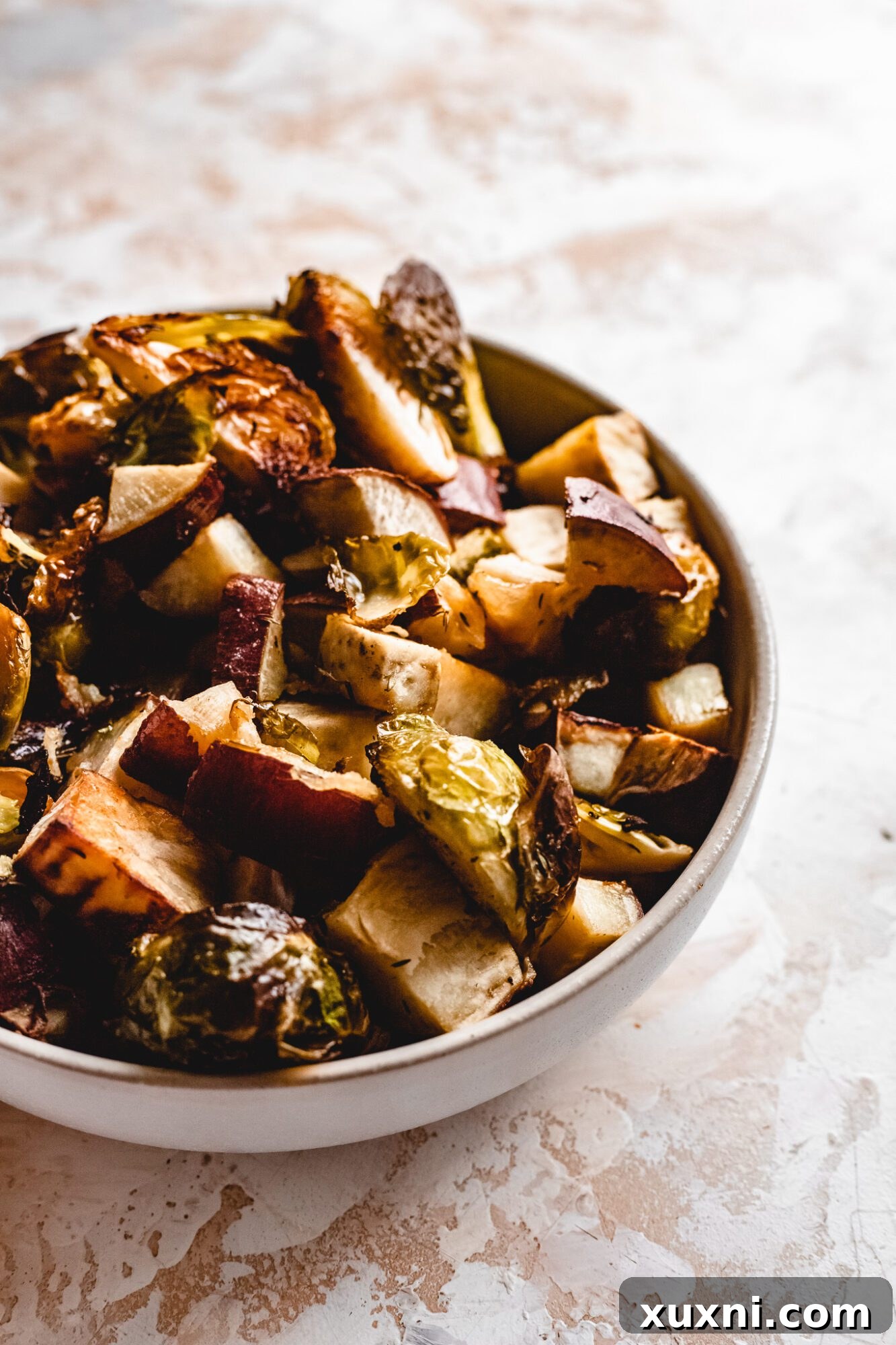A large bowl brimming with roasted Brussels sprouts, showing their crispy texture and delicious golden-brown edges.