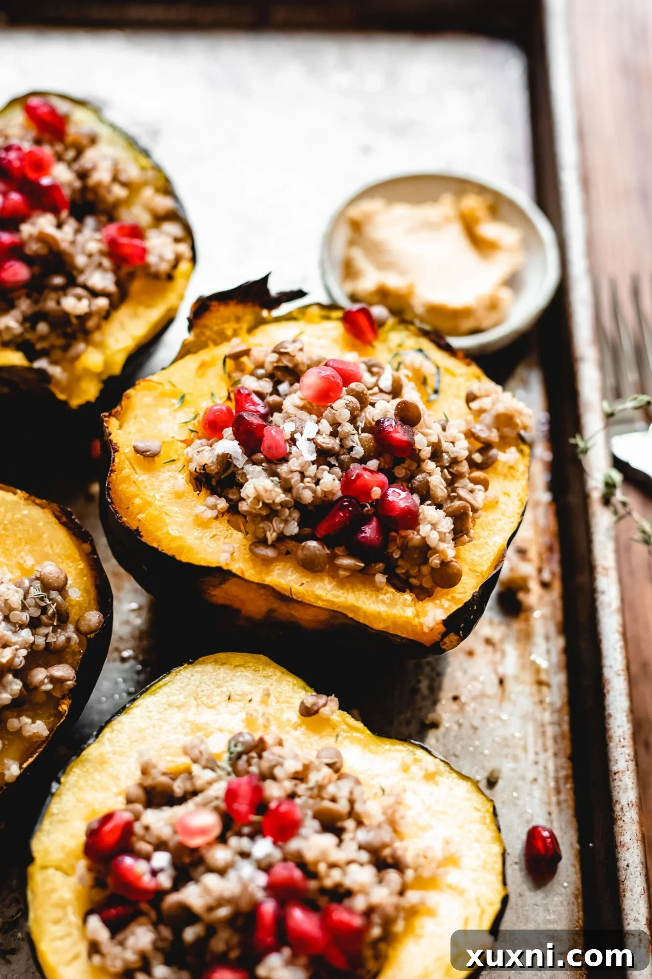 Plant-Powered Lentil Quinoa Stuffed Acorn Squash 3 vegetarian stuffed acorn squash on baking sheet