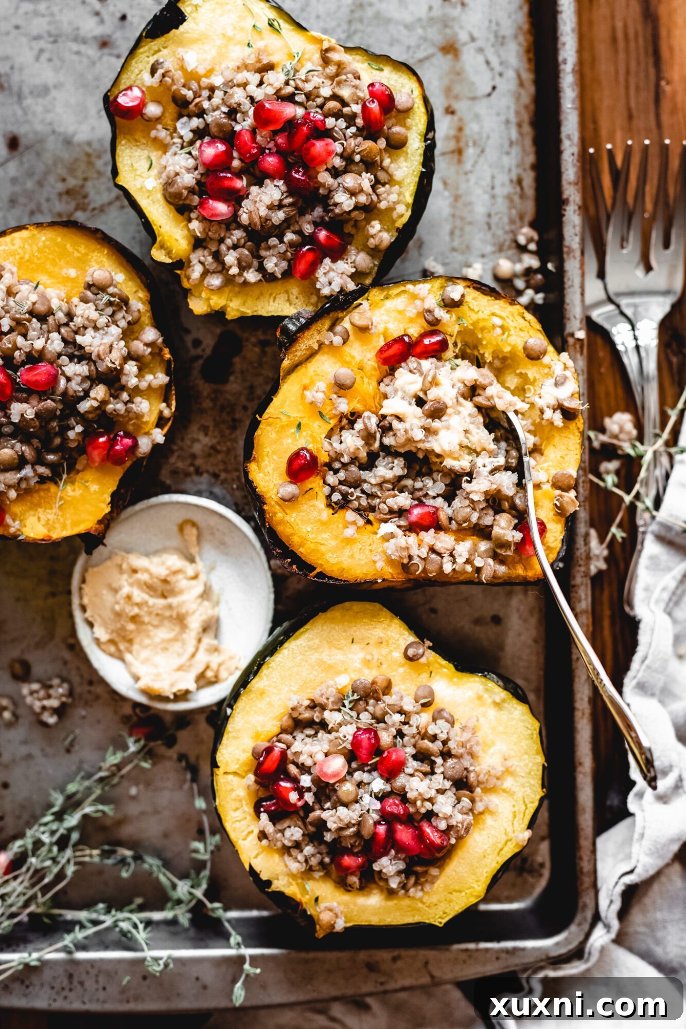 Plant-Powered Lentil Quinoa Stuffed Acorn Squash 7 fork eating quinoa stuffed acorn squash with pomegranate seeds