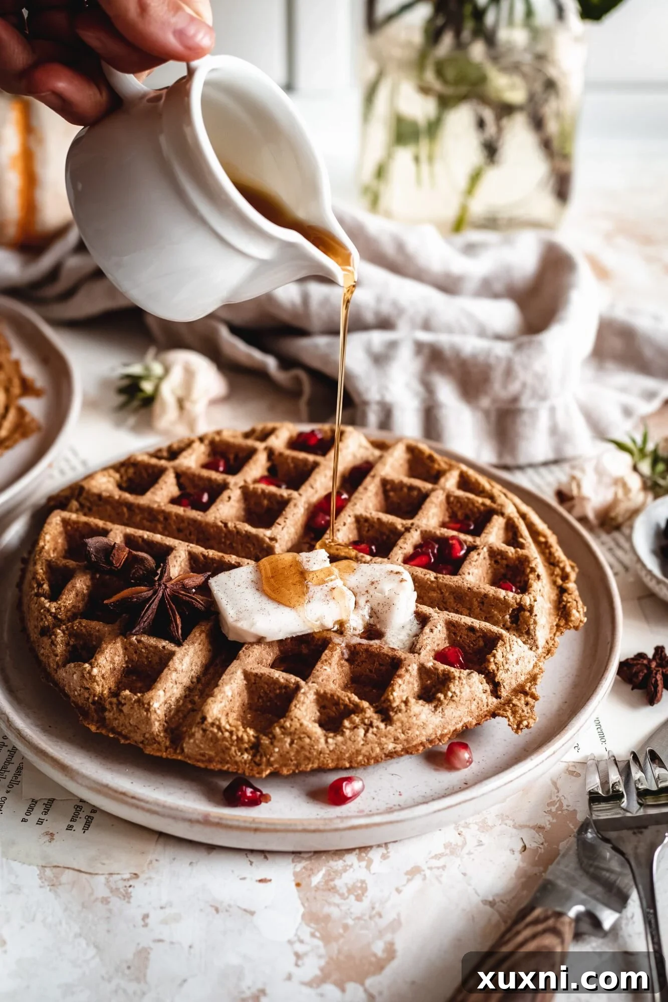 Effortless Gluten Free Vegan Pumpkin Waffles 3 Golden vegan pumpkin waffles generously drizzled with rich maple syrup