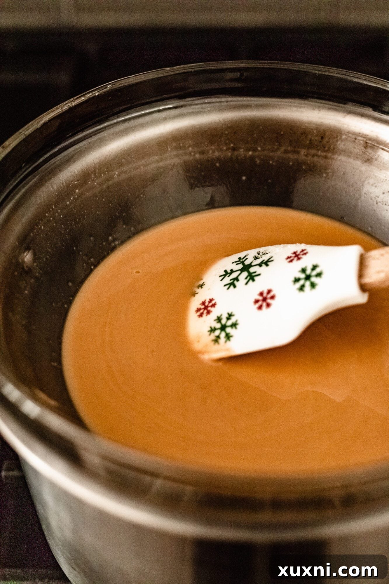 Melted vegan white chocolate mixture in a bowl, smooth and ready to be poured into molds.