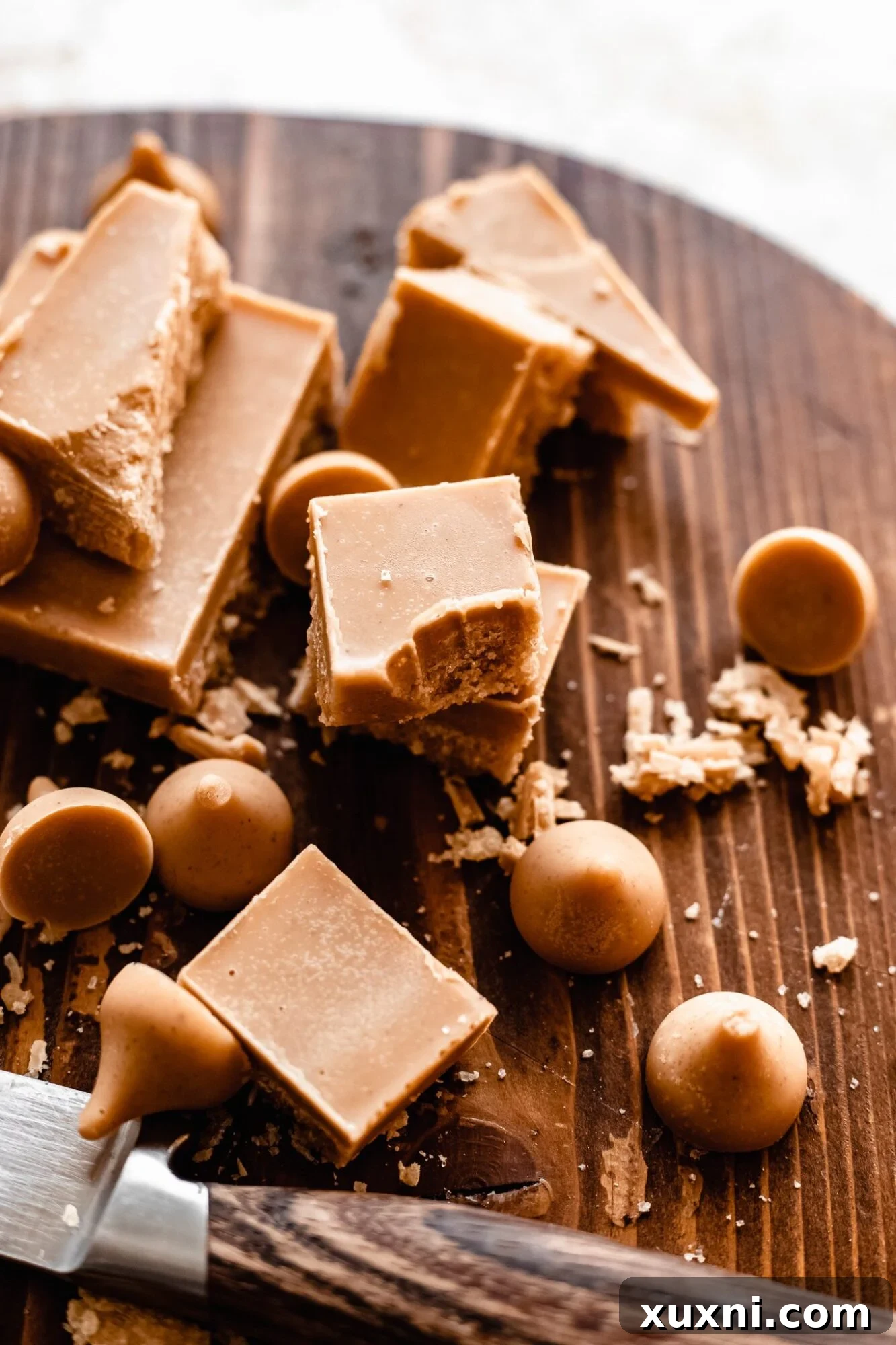 A piece of homemade vegan white chocolate with a bite taken out, showcasing its creamy texture.