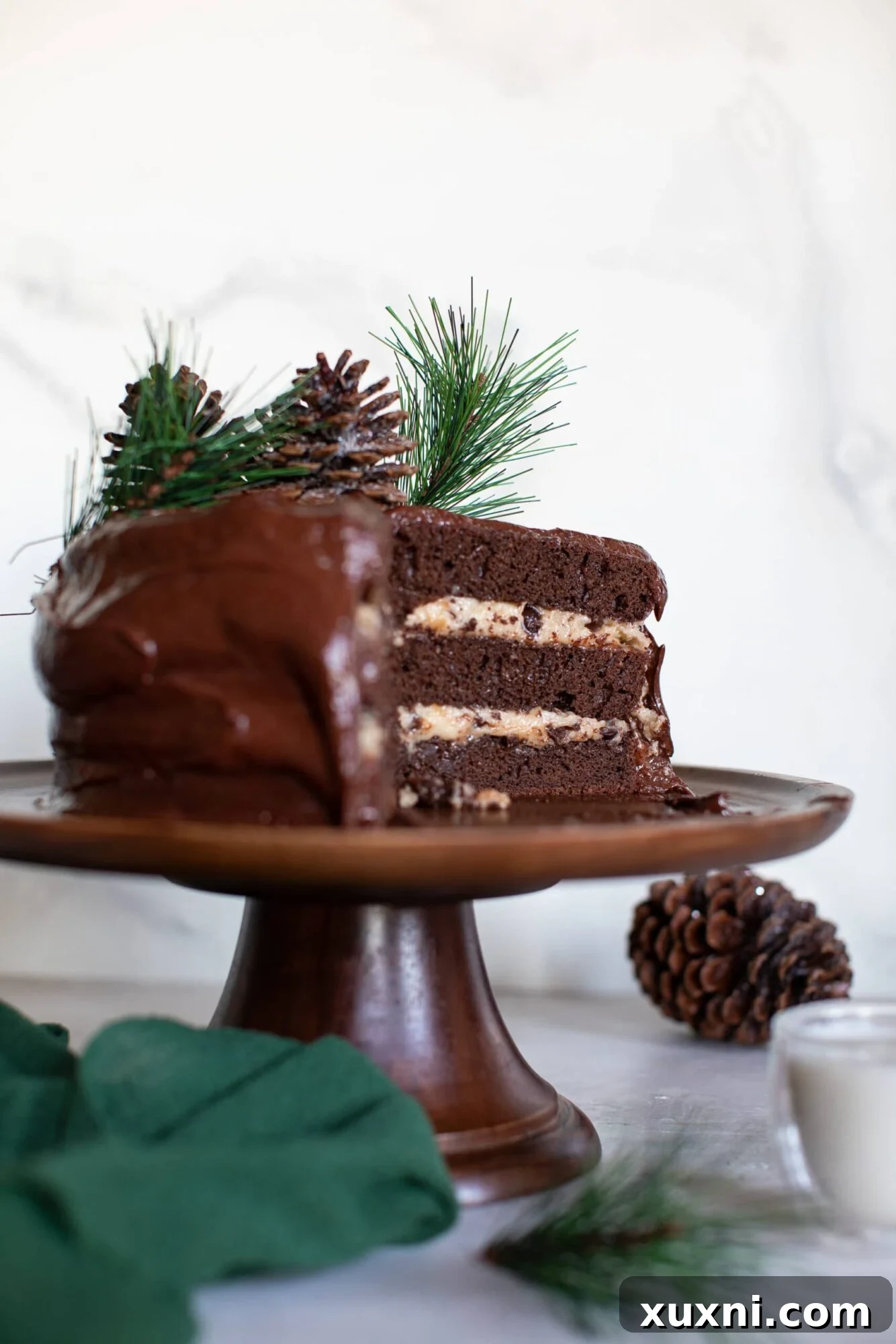 Close-up of a slice of Vegan Brownie Cookie Dough Cake, showing cookie dough frosting