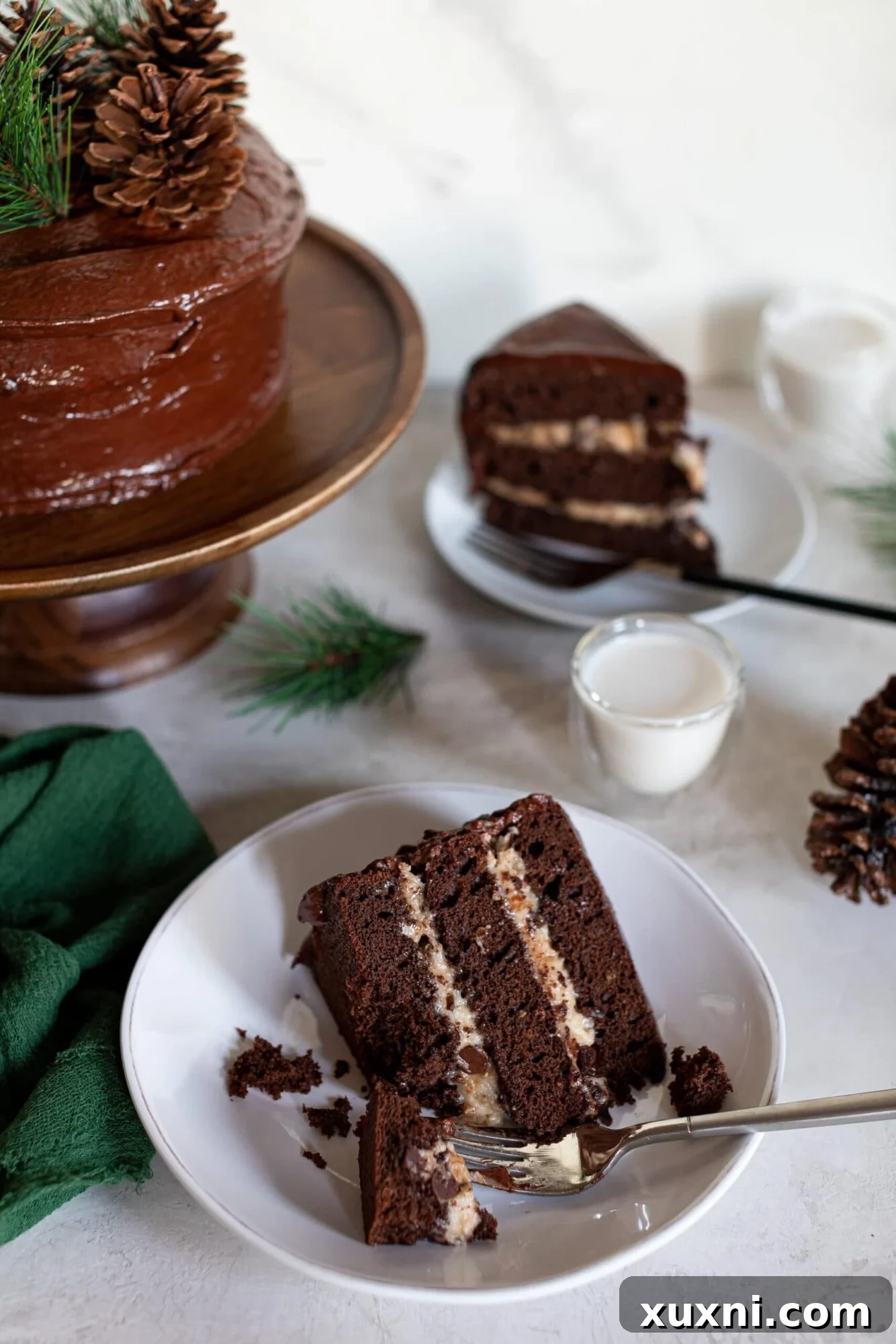 Multiple slices of Vegan Brownie Cookie Dough Cake on a dark surface