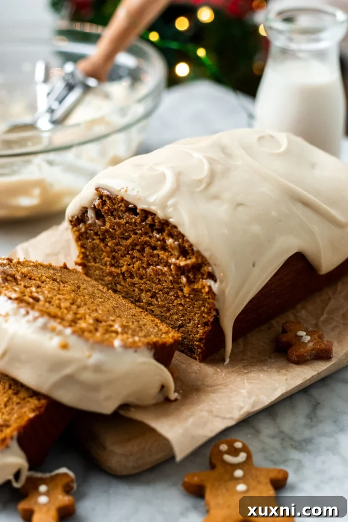 A beautifully sliced vegan gingerbread loaf cake, showcasing its moist texture and perfect crumb, resting on a rustic wooden board, ready to be served during the holidays.