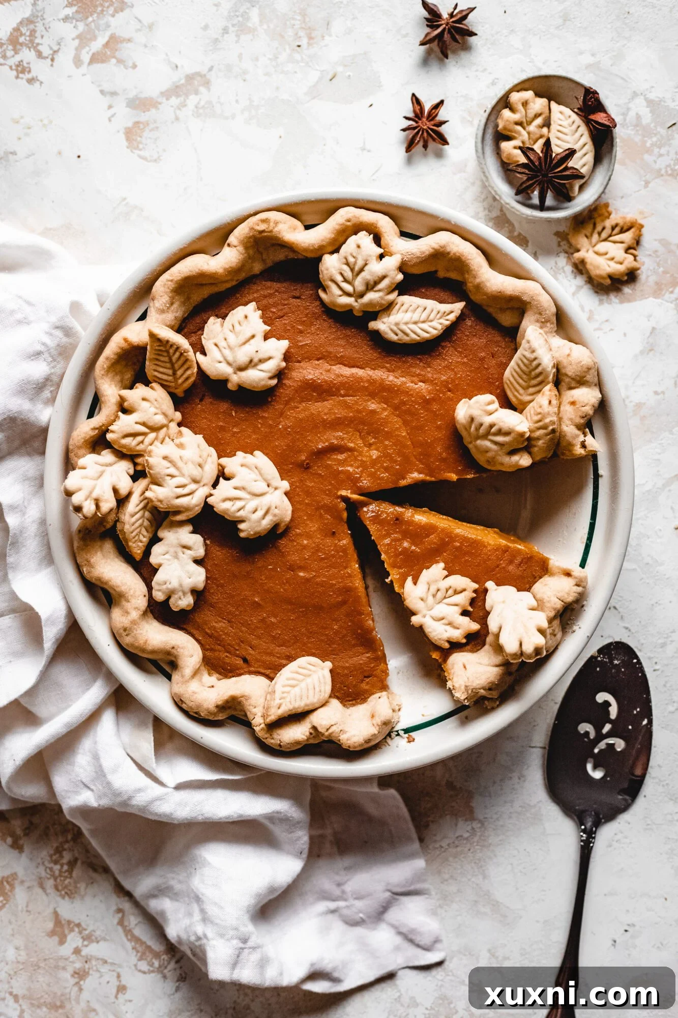 A beautifully sliced vegan butternut squash pie, revealing its rich, creamy texture and golden crust.