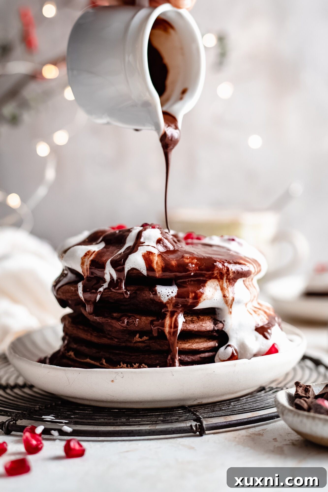Hot chocolate sauce drizzled over freshly made vegan chocolate pancakes.