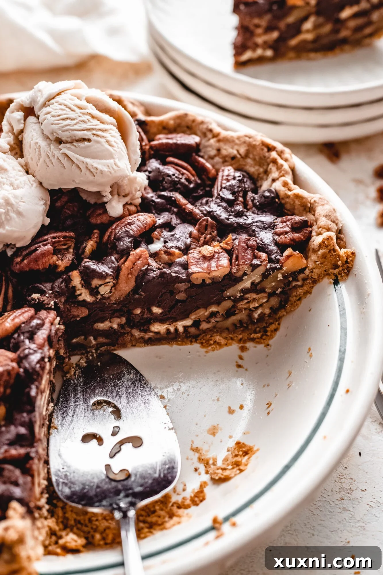 Gooey vegan chocolate pecan pie cooling on a wire rack.