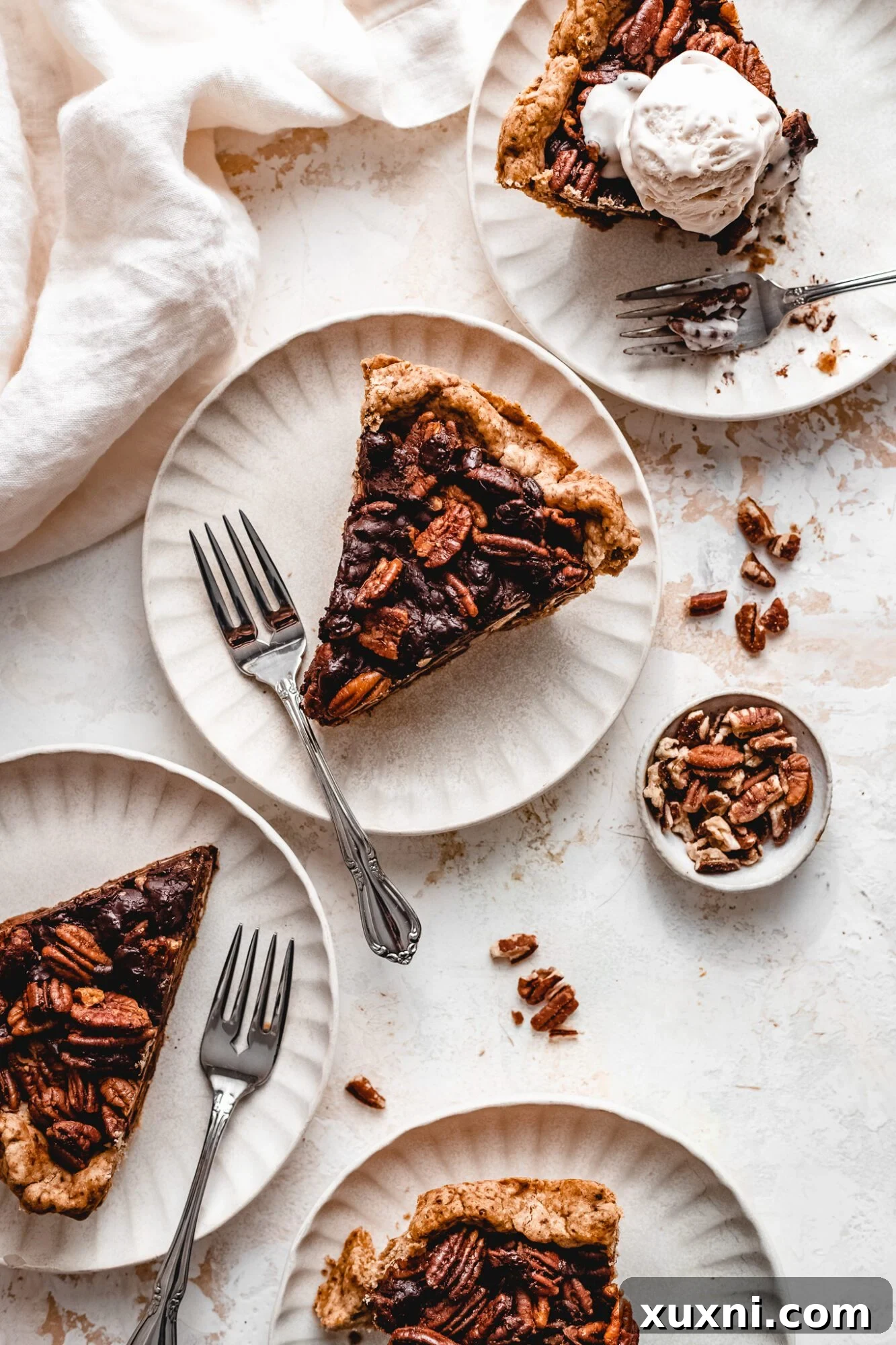 A festive spread of vegan Thanksgiving desserts, featuring chocolate pecan pie.