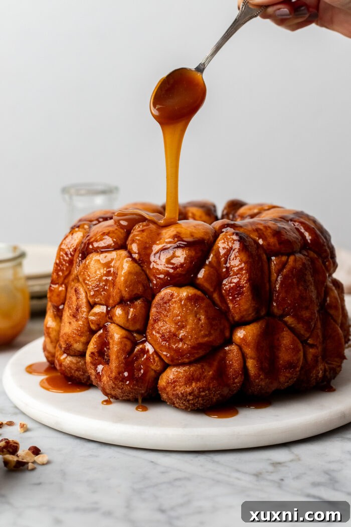 The Ultimate Easy Vegan Pull-Apart Bread 12 Drizzling caramel sauce over freshly baked vegan monkey bread.