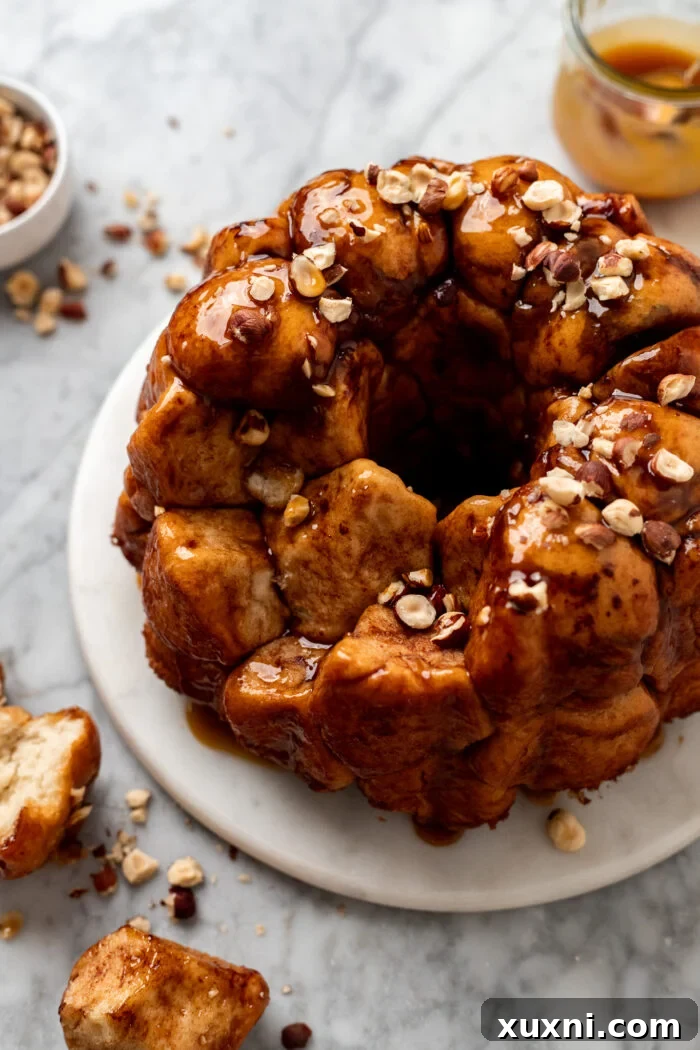 The Ultimate Easy Vegan Pull-Apart Bread 16 A baked piece of vegan monkey bread being pulled off, showcasing its texture.