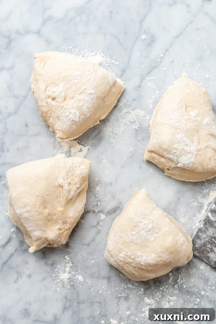 The Ultimate Easy Vegan Pull-Apart Bread 5 Monkey bread dough divided into four equal sections on a floured surface.