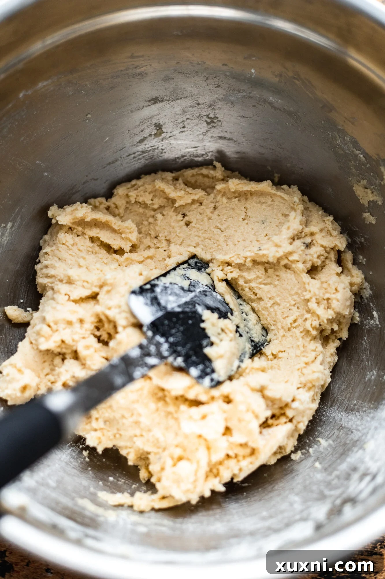 A disc of perfectly chilled vegan sugar cookie dough, ready for rolling and cutting.