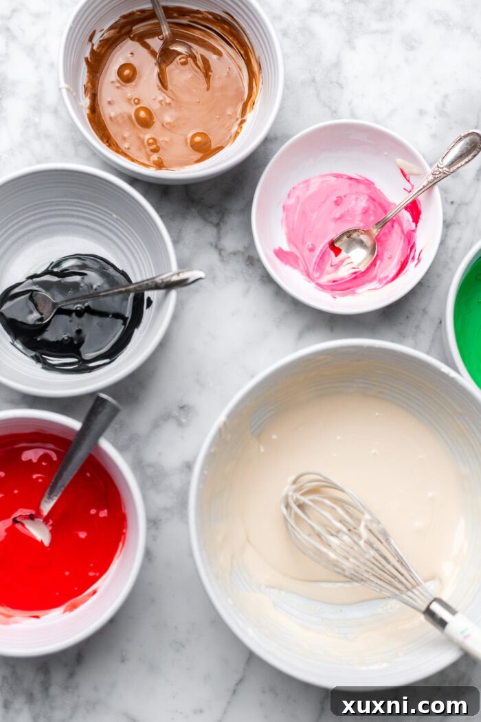 Bowls of different colored vegan royal icing, ready for decoration