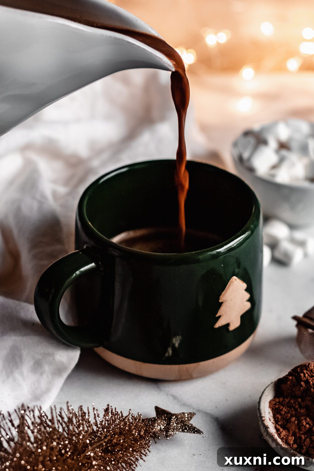 Pouring vegan peppermint mocha into a mug for serving.