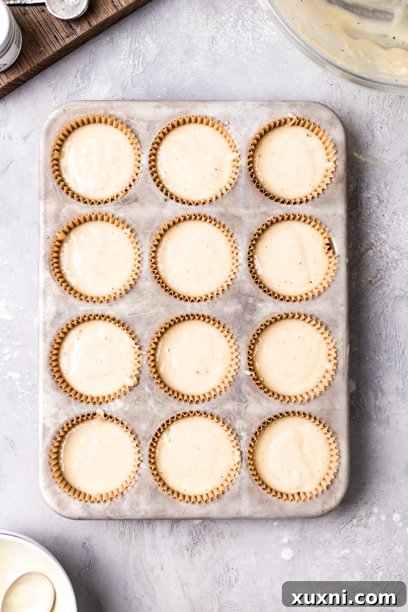 Unbaked vegan white chocolate cupcake batter in liners