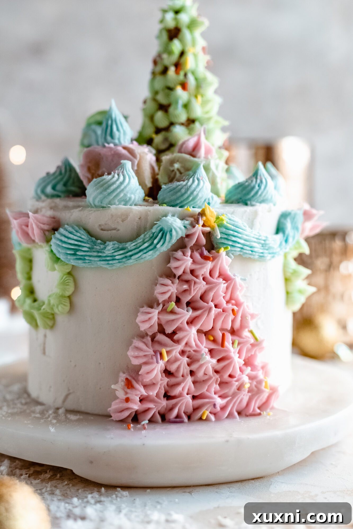 Pink frosting Christmas tree piped on the side of a cake