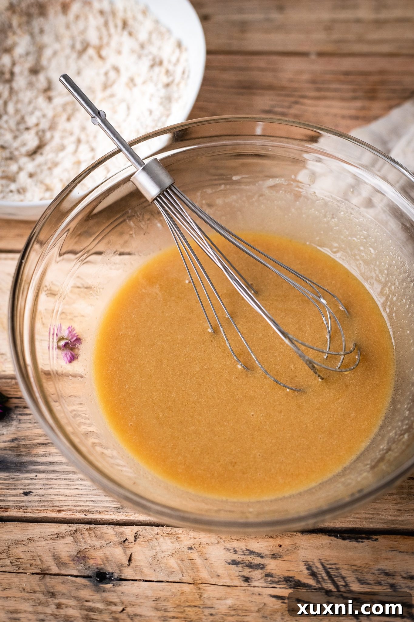 Hand mixing vegan oatmeal cookie dough in a bowl