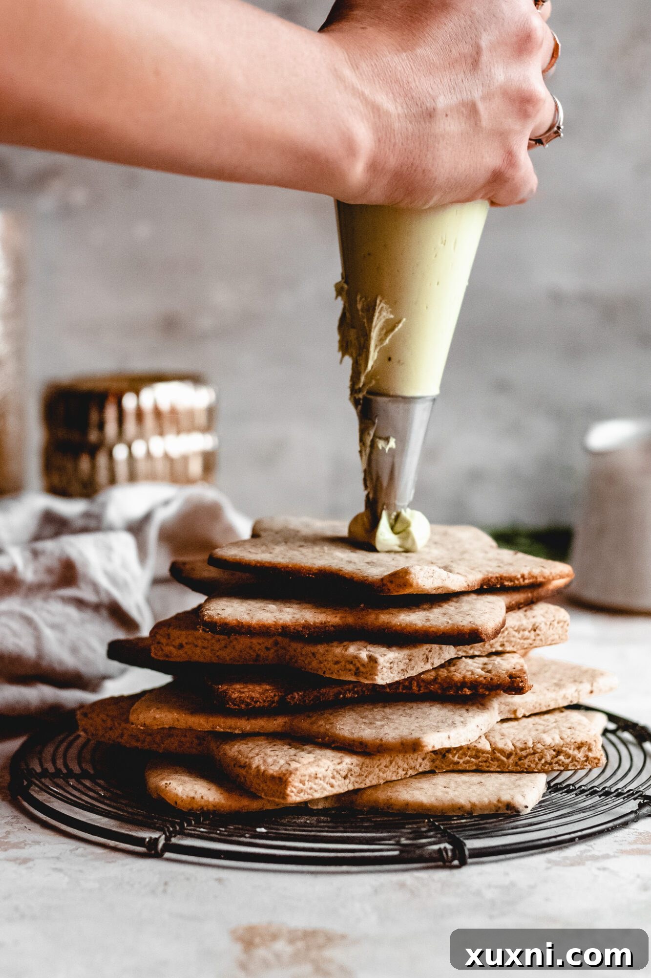 hand piping buttercream onto cookie tree