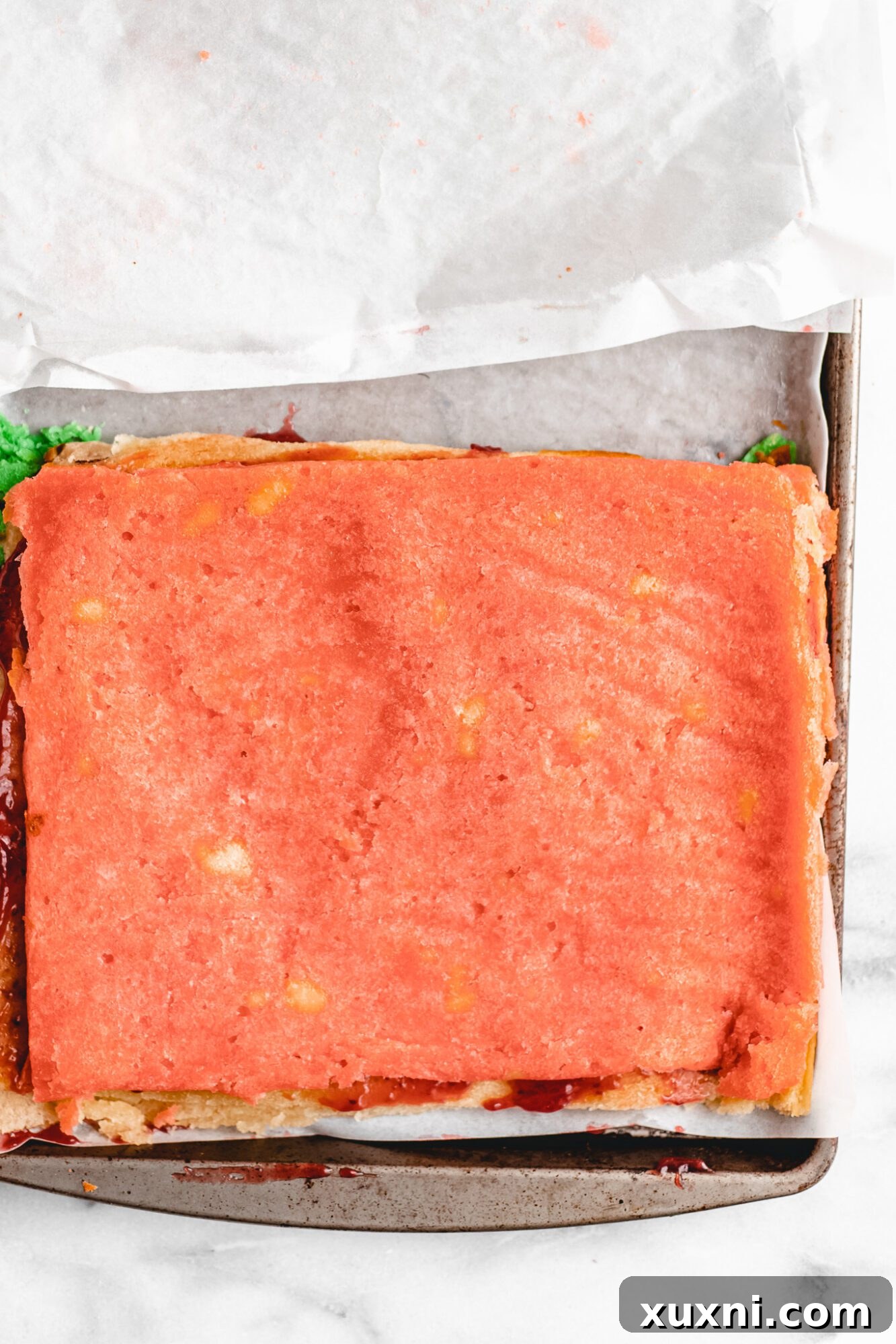 The third and final layer of tricolor cookie being positioned.