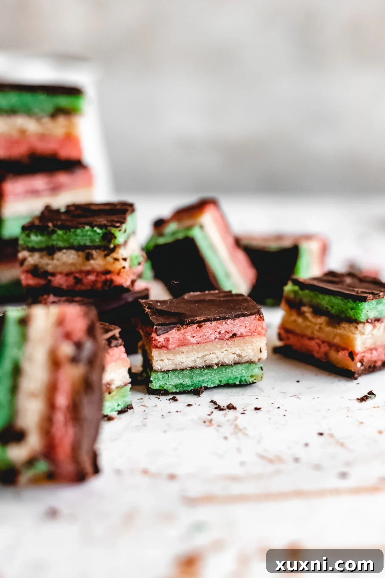 A stack of vibrant tricolor cookies, perfectly layered.