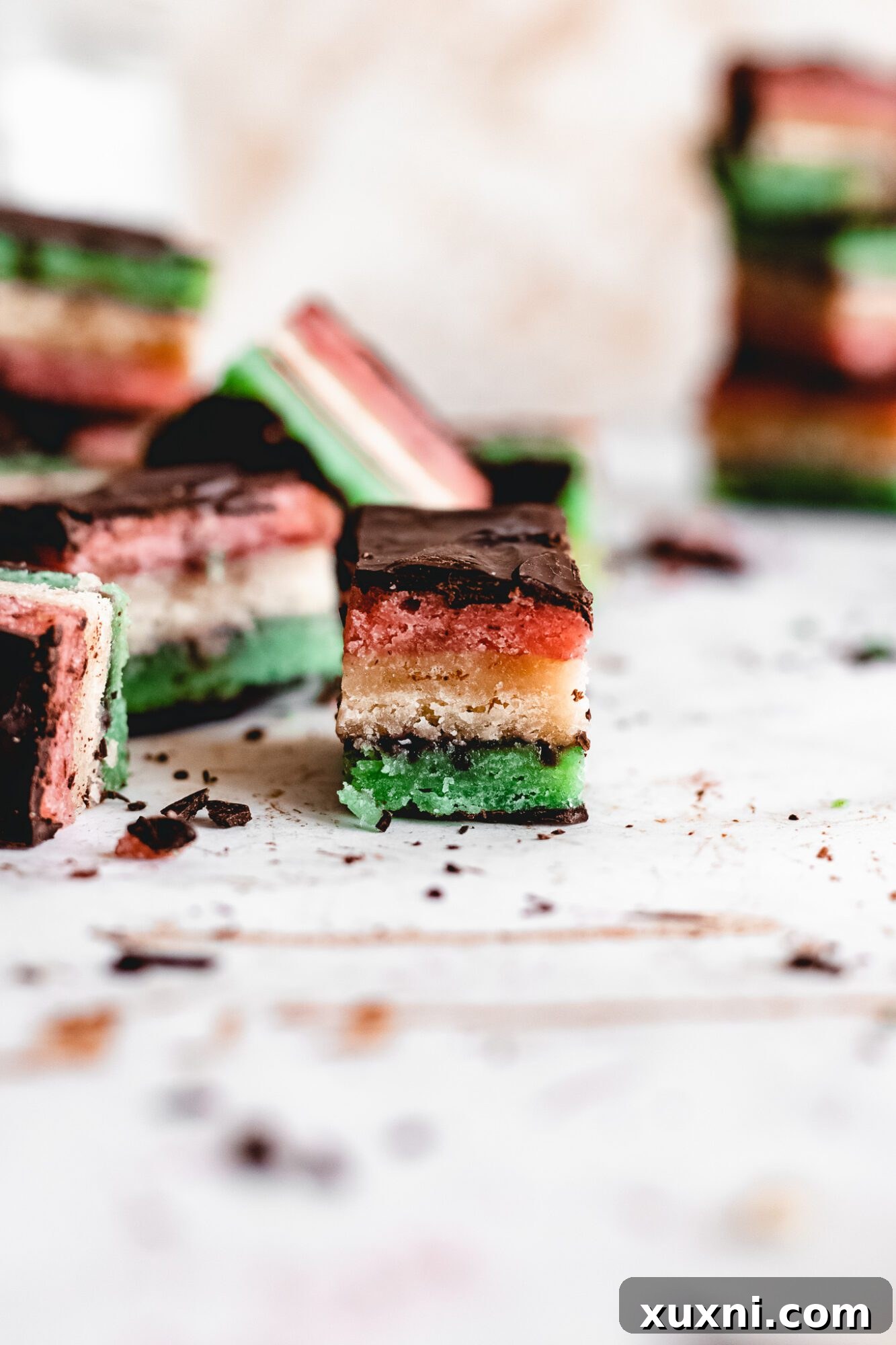 A festive display of Italian rainbow cookies with green and red layers.