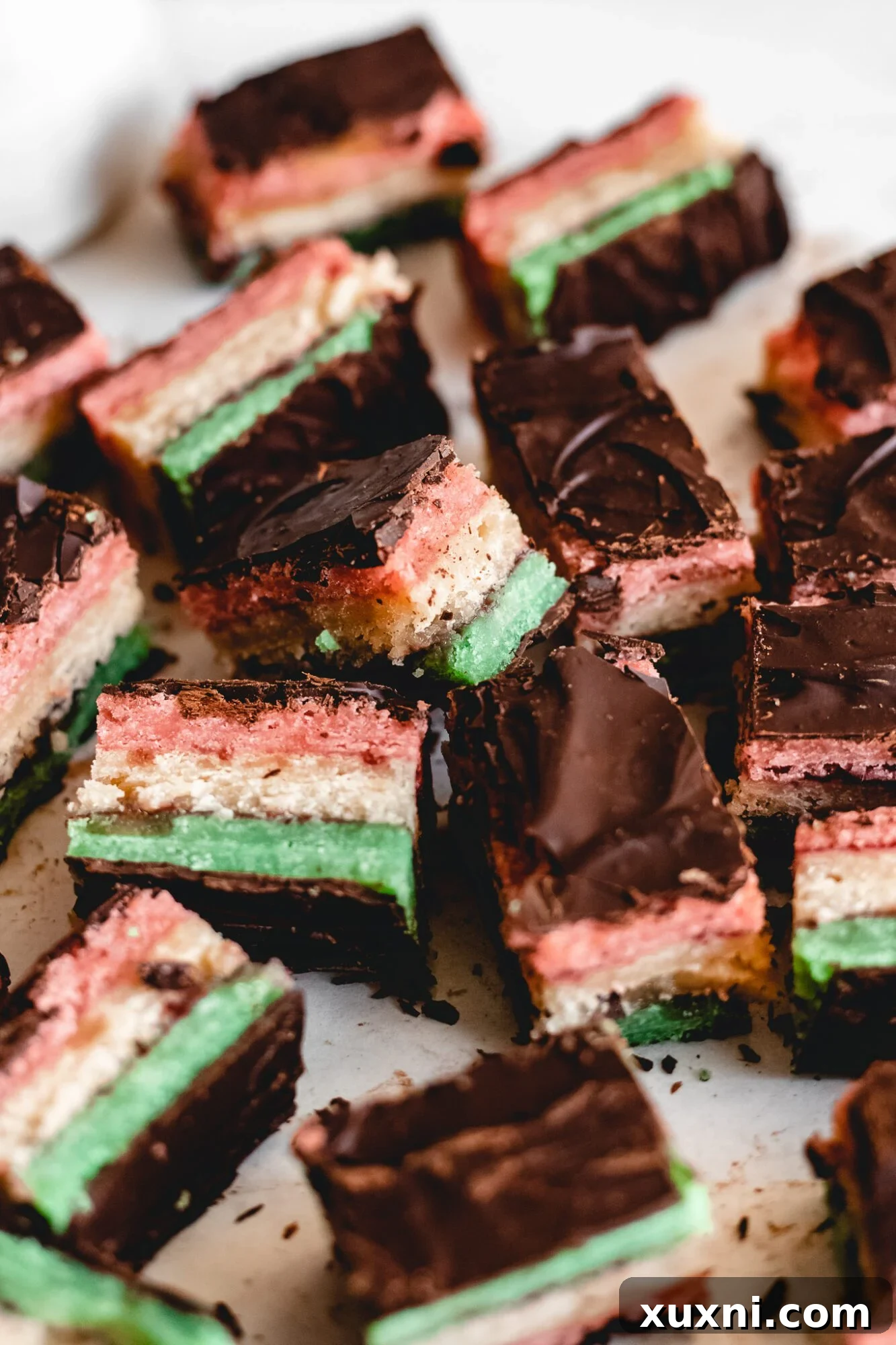 A tray of freshly baked vegan Italian rainbow cookie layers, ready for assembly.