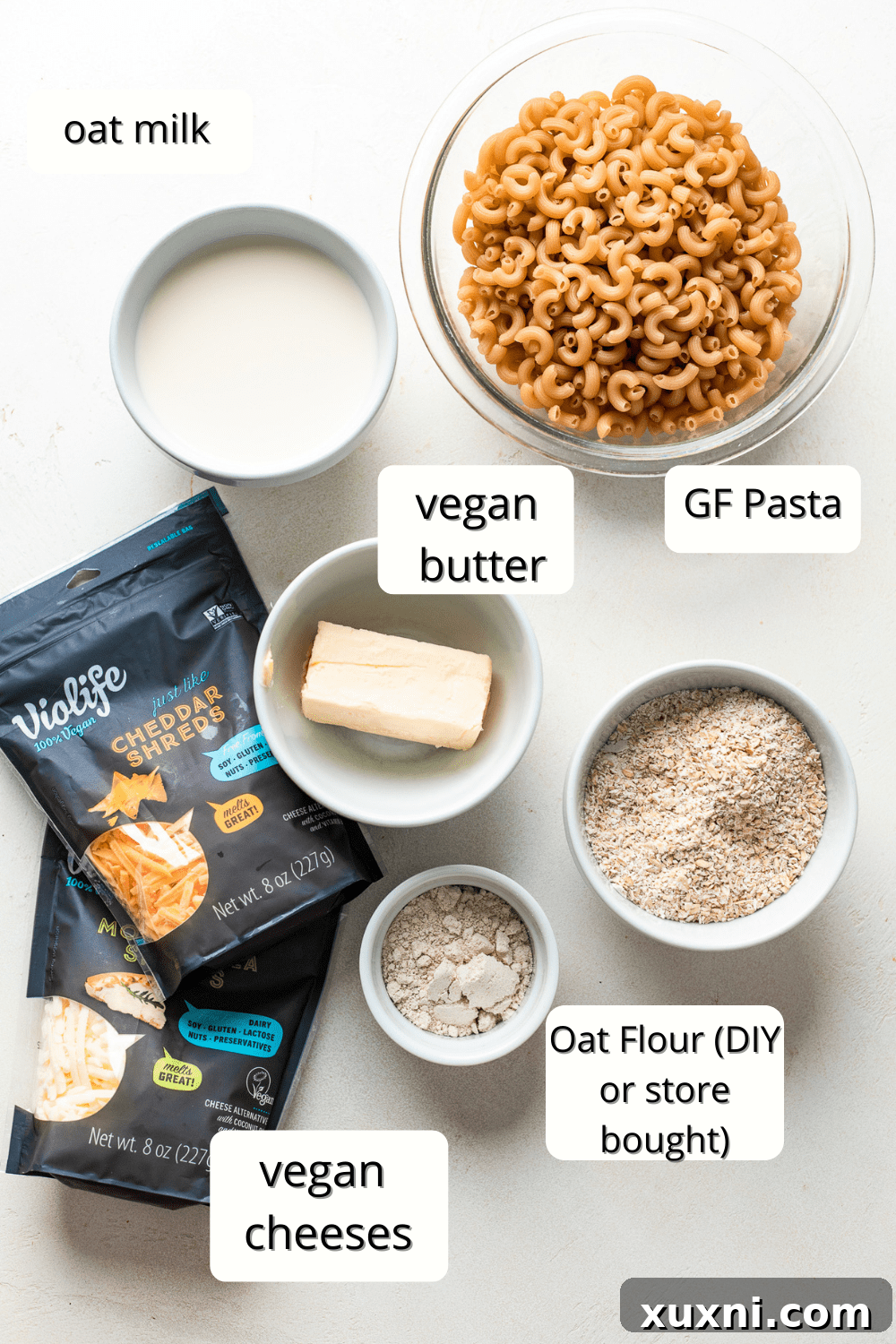 All the essential ingredients for making vegan mac and cheese, laid out on a kitchen counter.