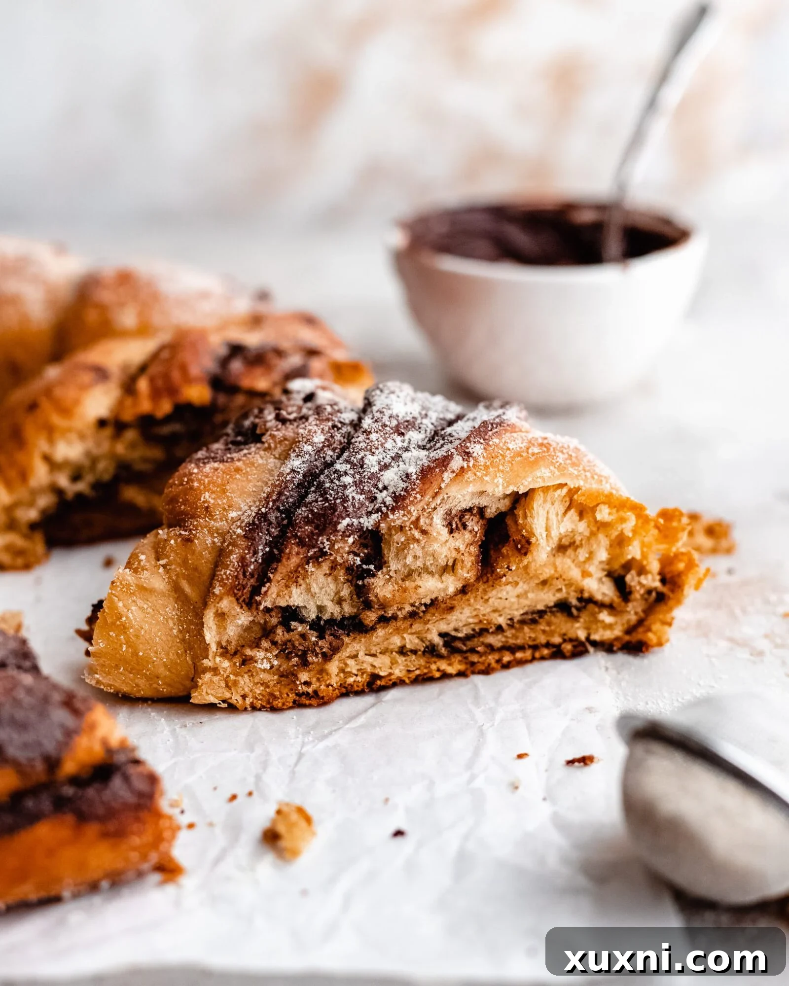 Slices of a decadent vegan chocolate hazelnut bread wreath showing rich swirls