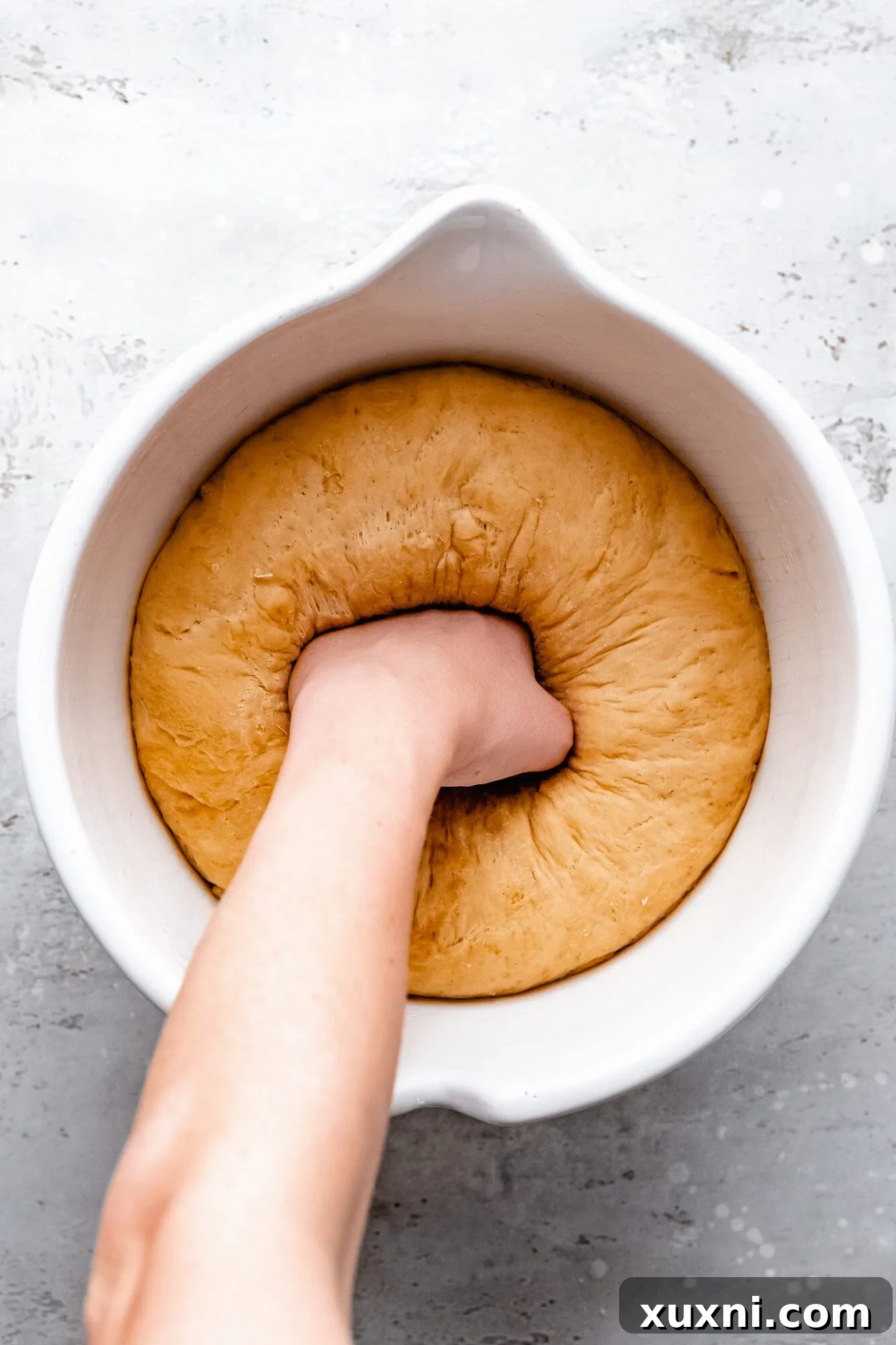 Punching down the risen vegan dough