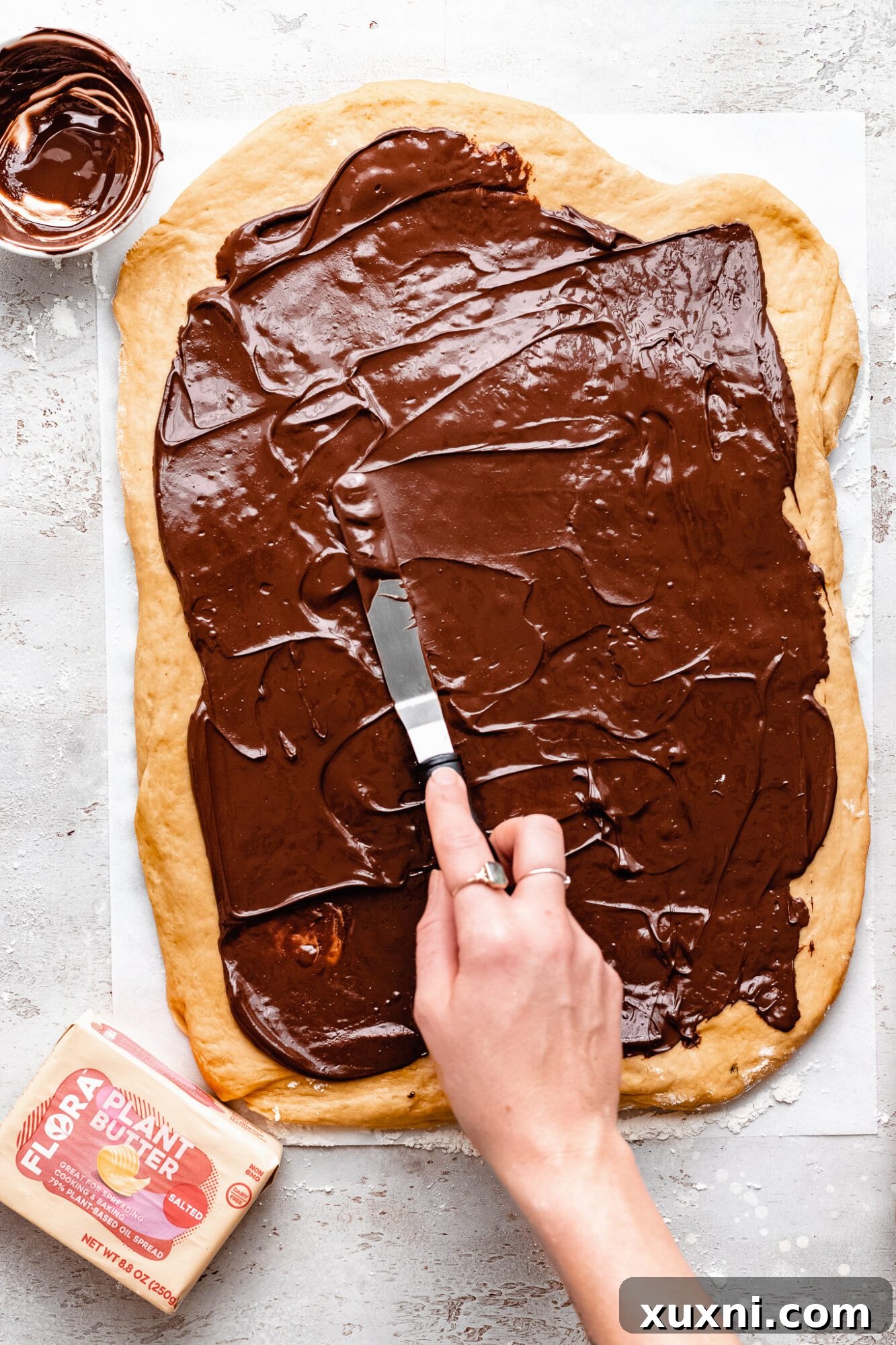 Chocolate hazelnut spread generously applied onto bread wreath dough