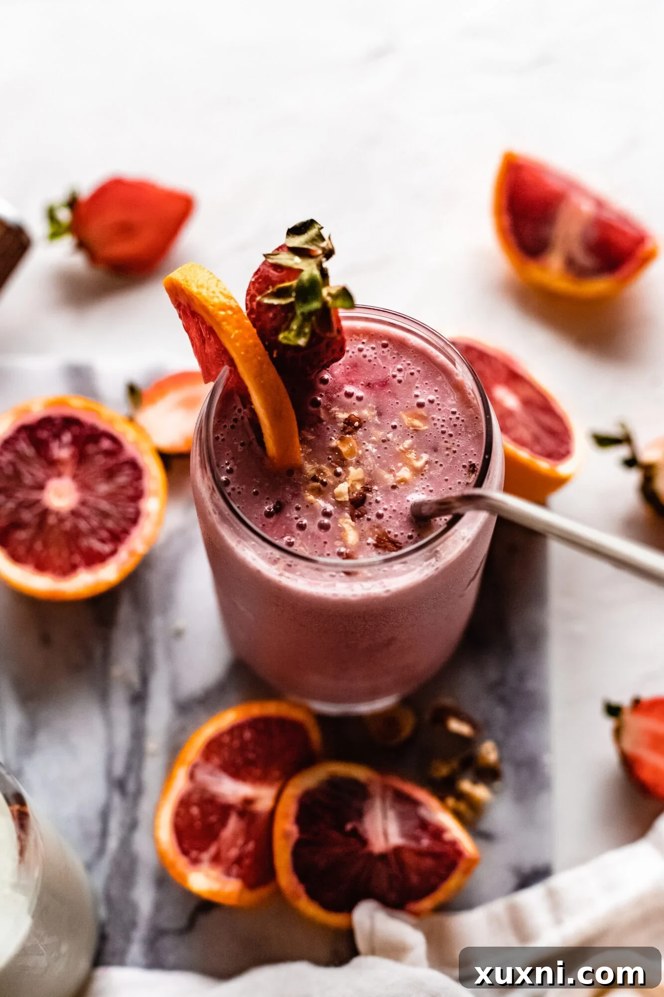 Close-up of a refreshing vegan citrus smoothie in a glass with a straw