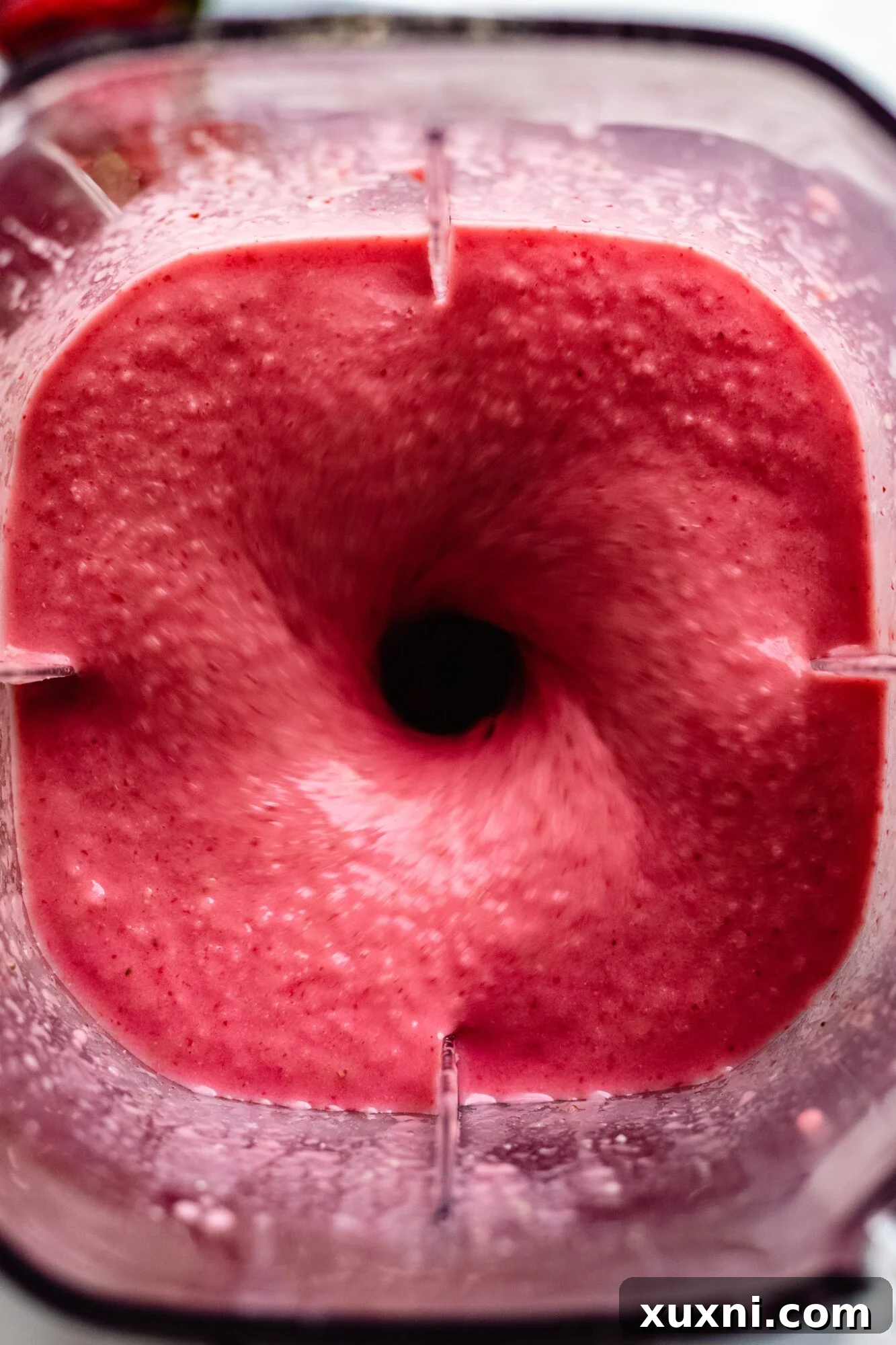 A perfectly blended Immune Boosting Strawberry Orange Smoothie (Protein Packed!) in a glass