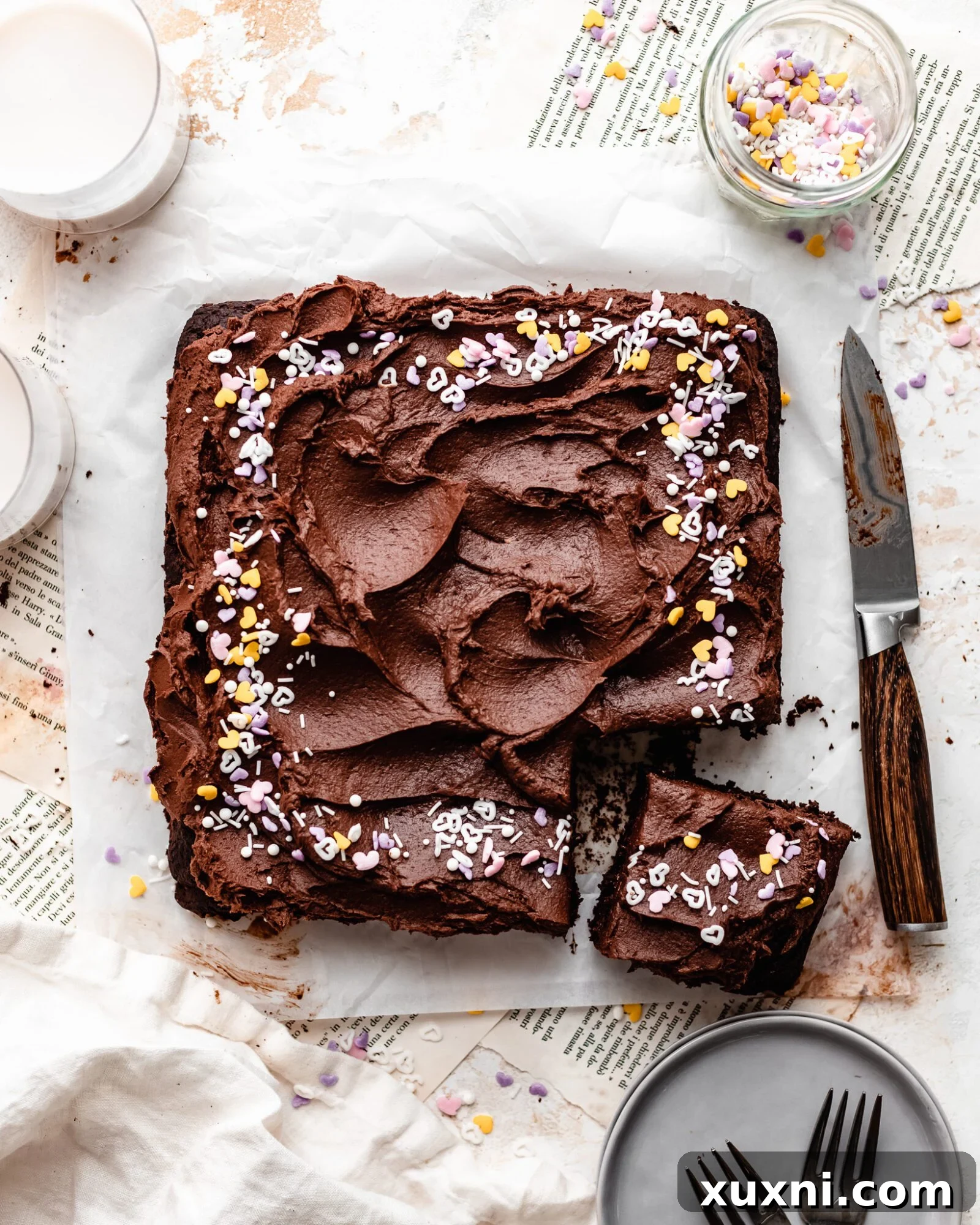 Sliced vegan gluten-free chocolate cake adorned with colorful sprinkles, showcasing its rich, moist texture.
