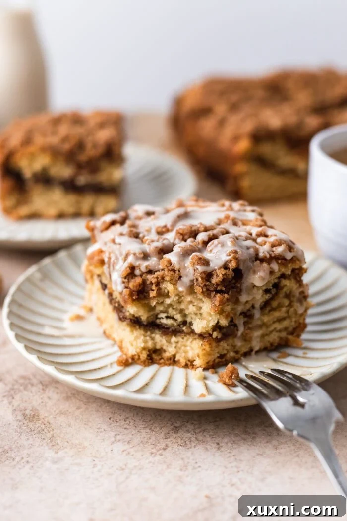vegan coffee cake on a plate with simple powdered sugar glaze