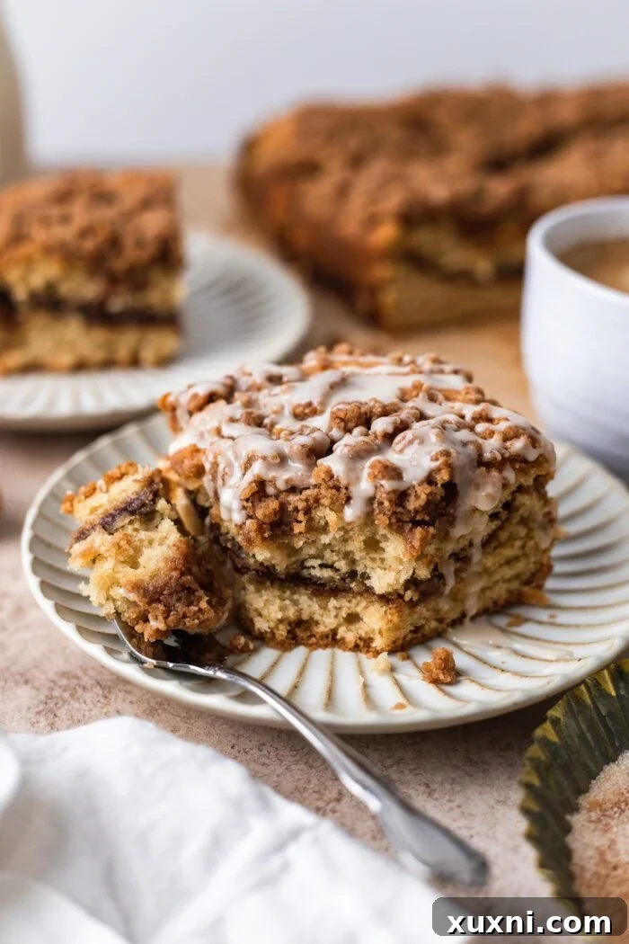 slice of vegan coffee cake on a white plate with fork