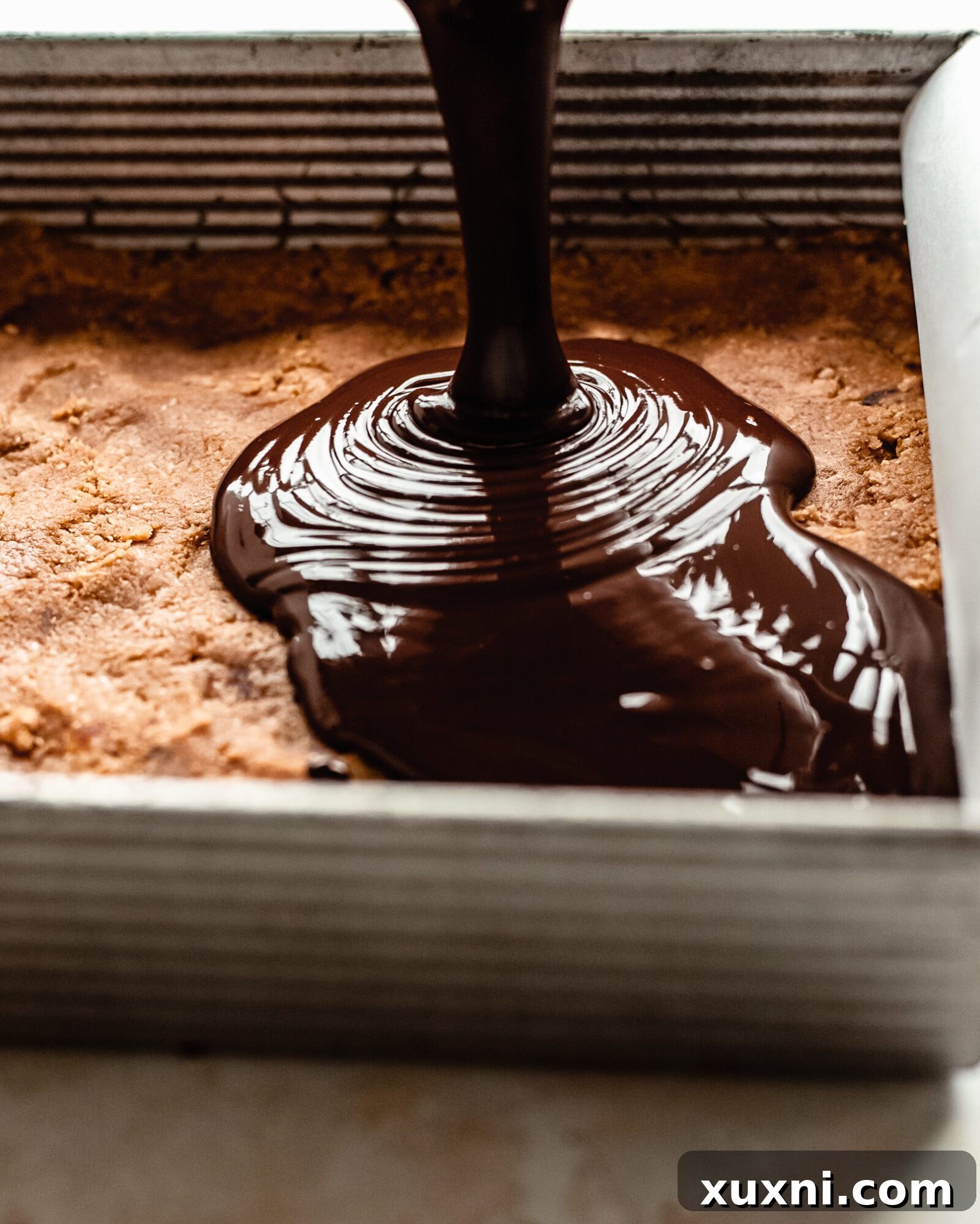 chocolate being poured onto bars